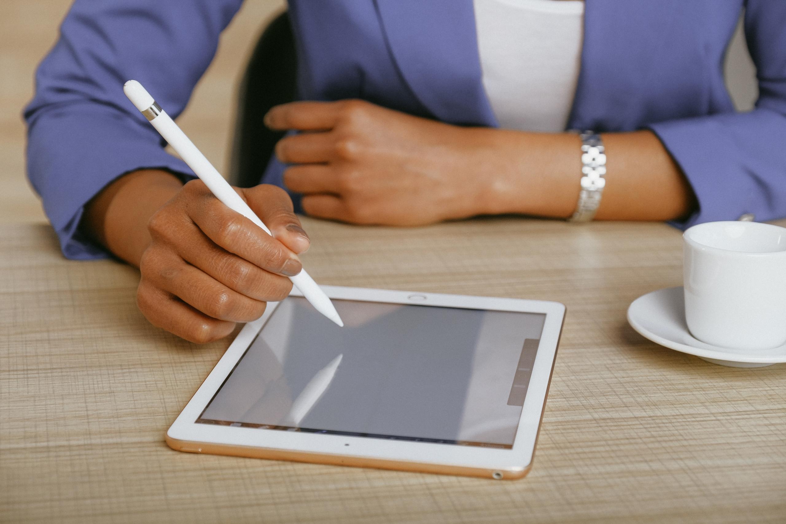 person working on iPad at desk