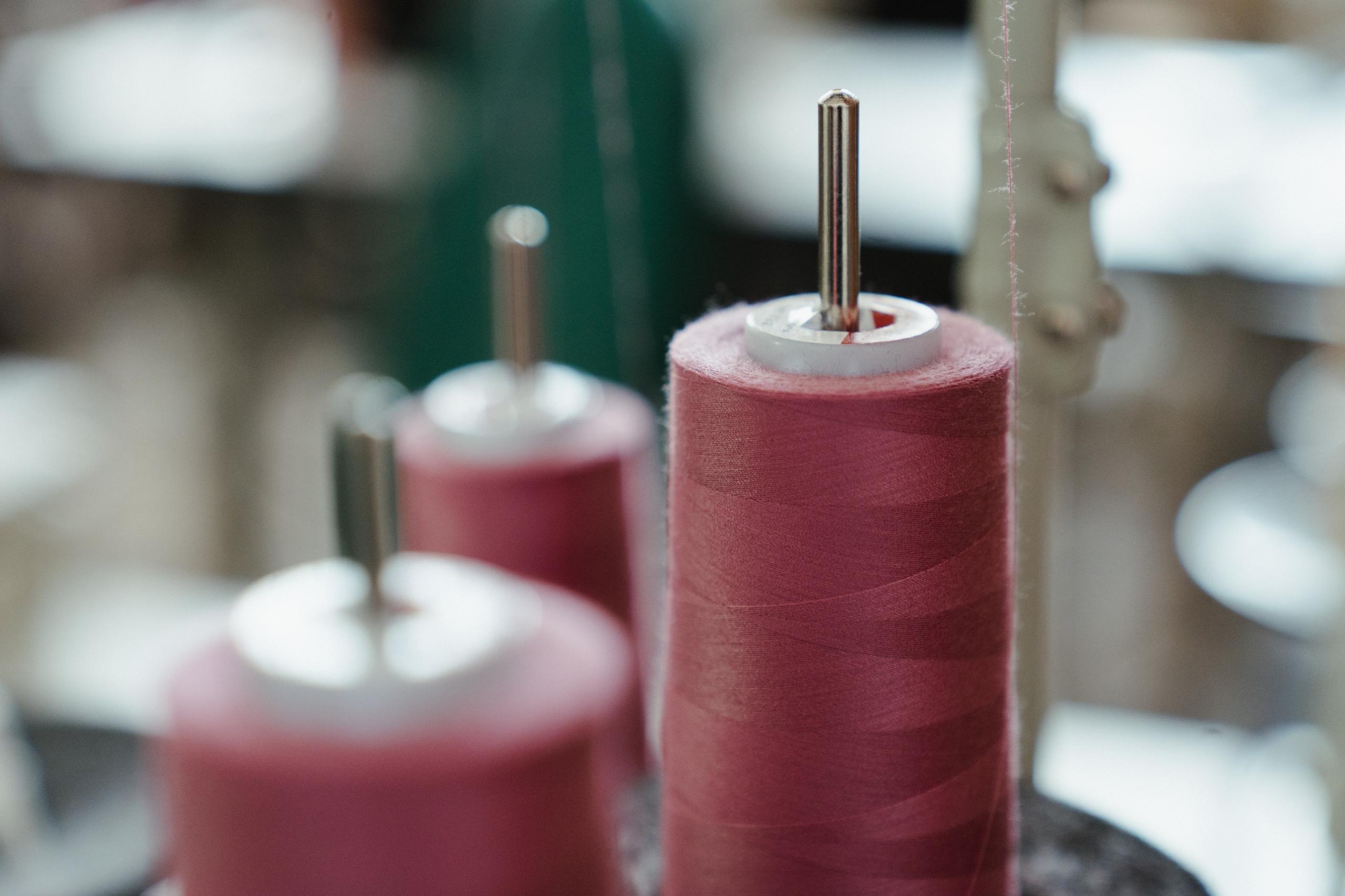 spools of pink cotton thread