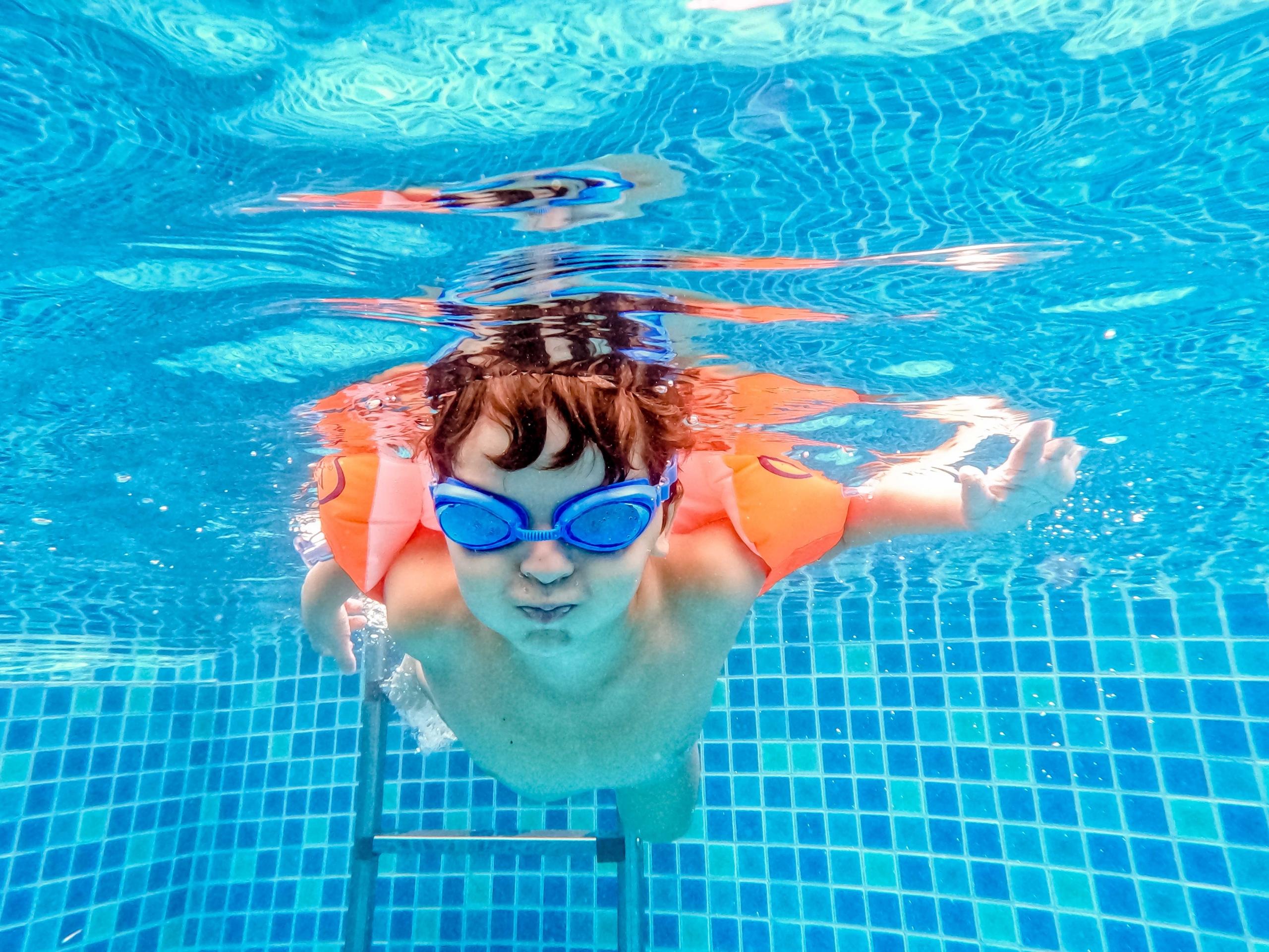 young boy swimming underwater