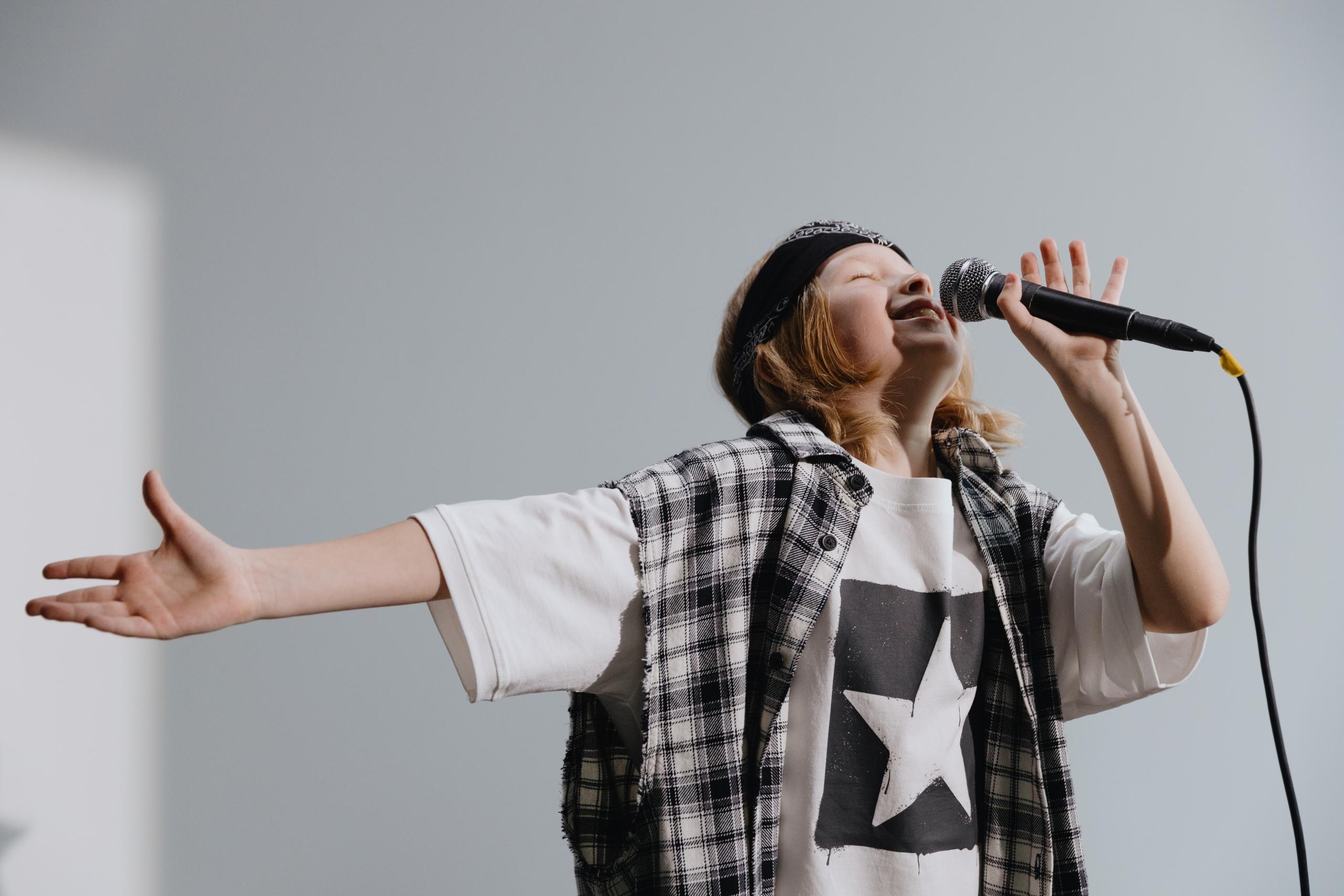 boy singing into microphone