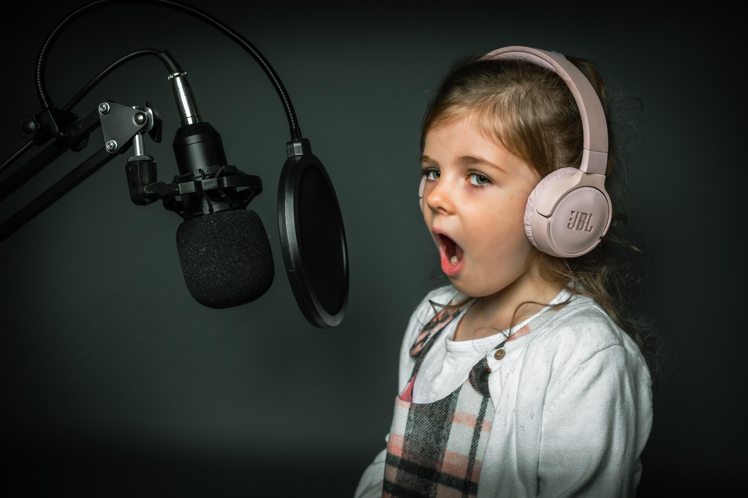 girl in recording studio wearing headphones