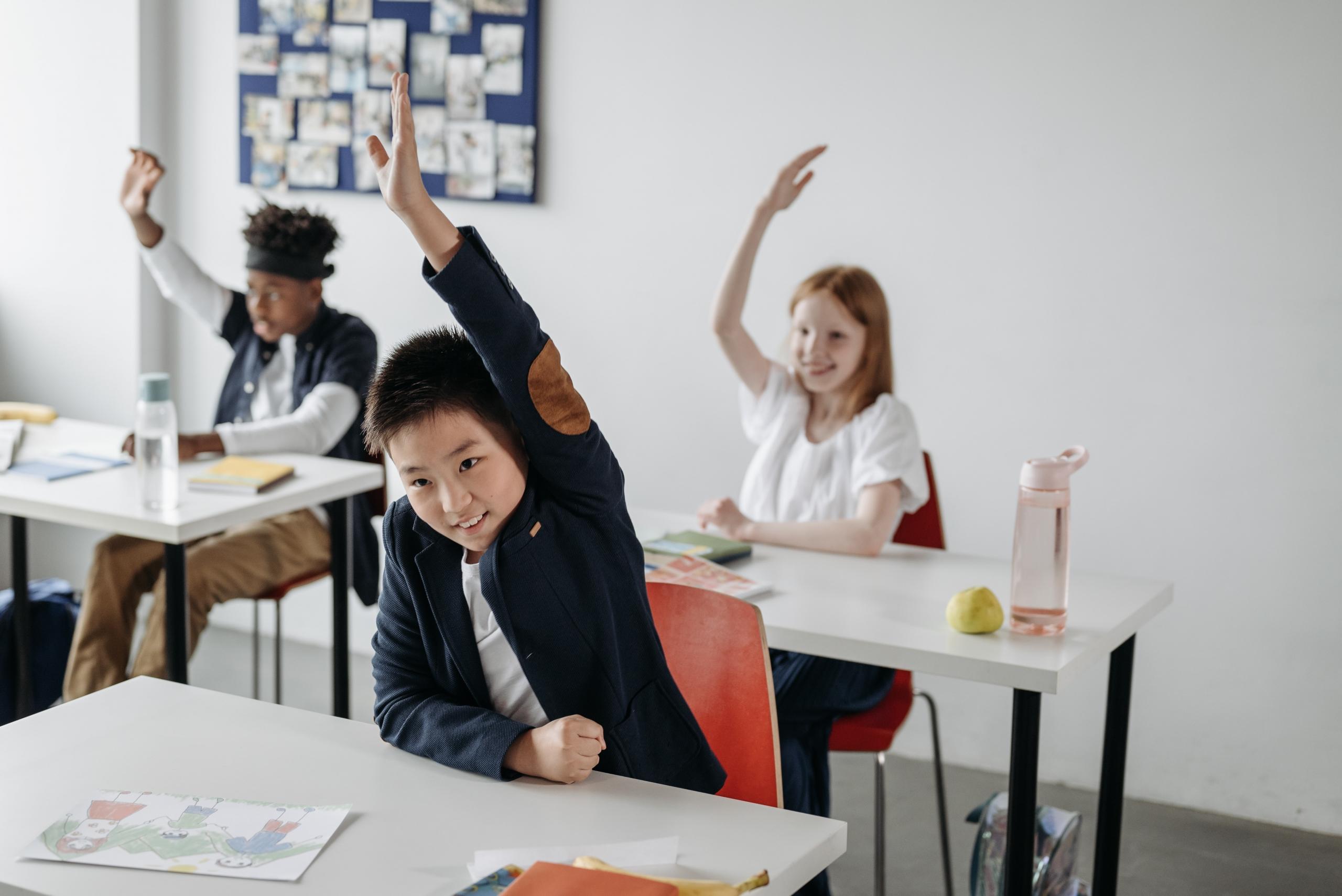 young students in a classroom seated behind desks