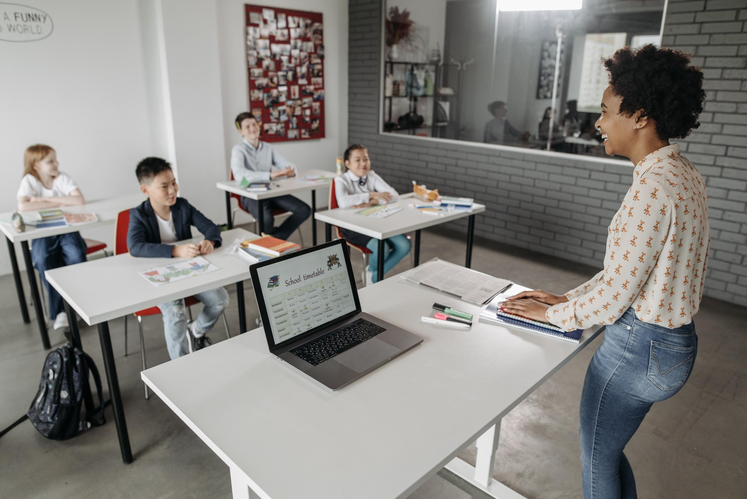 students and teacher laughing in classroom