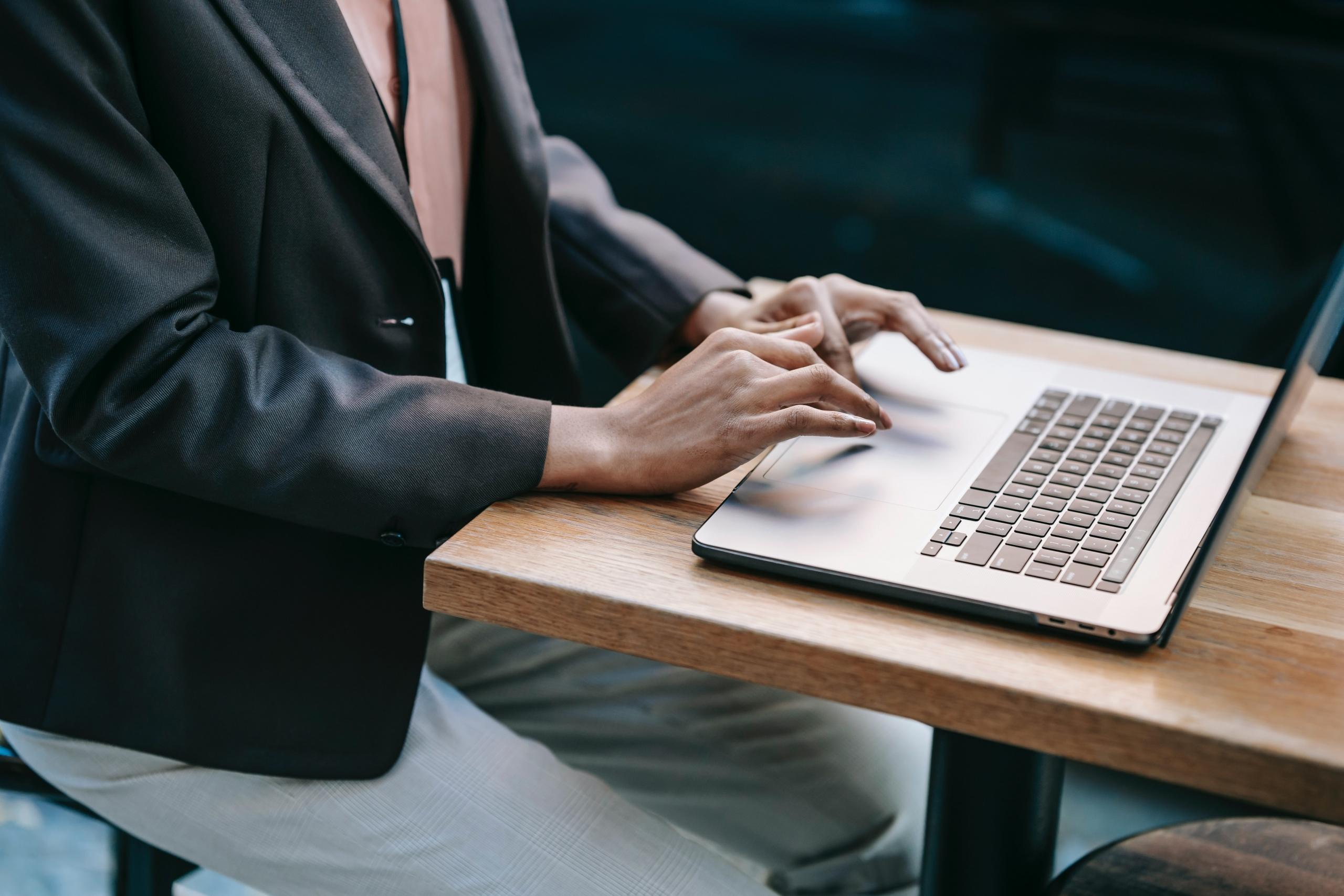 person typing on laptop keyboard