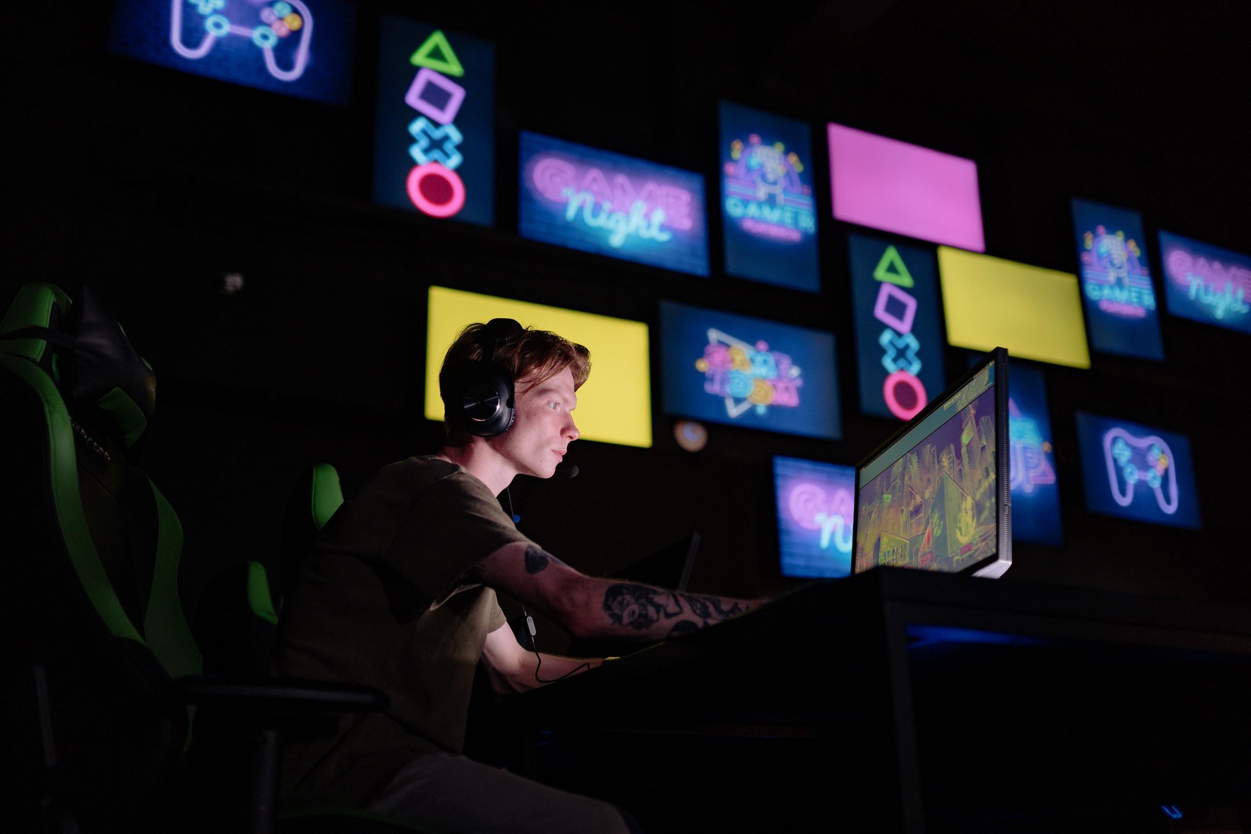 person playing video games using multiple screens