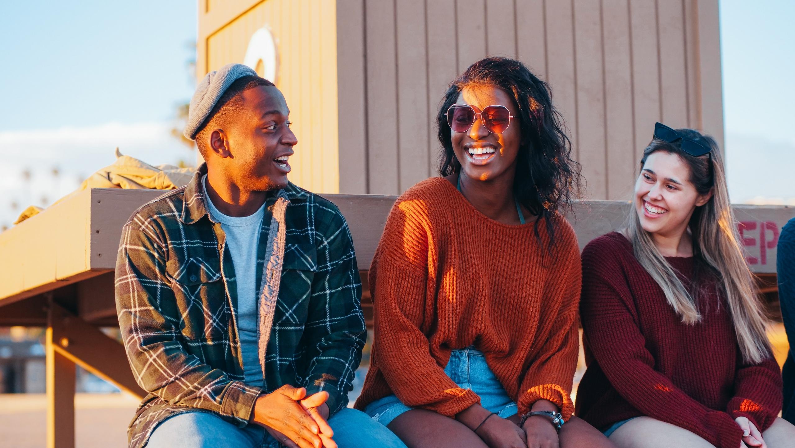 a group of woman and men laughing together