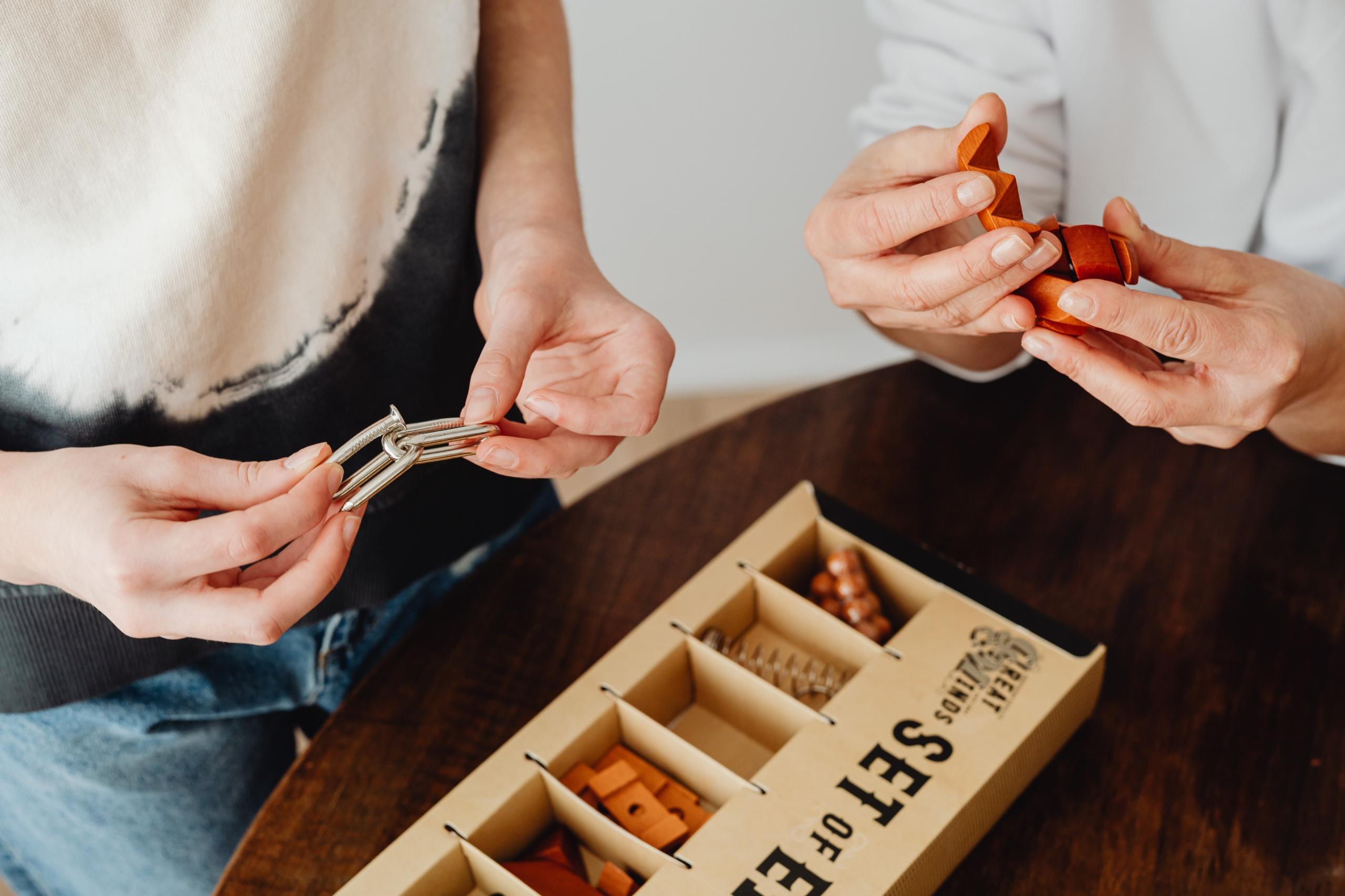 two people taking out the pieces of an educational game