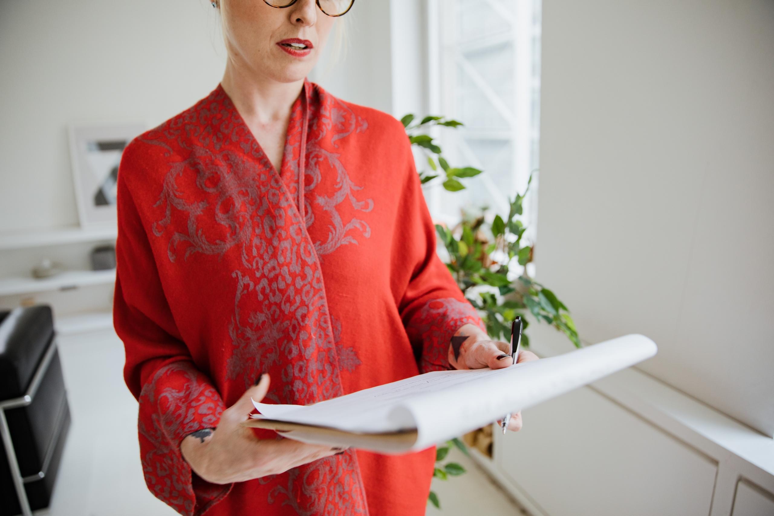 woman reading notes taken in notepad