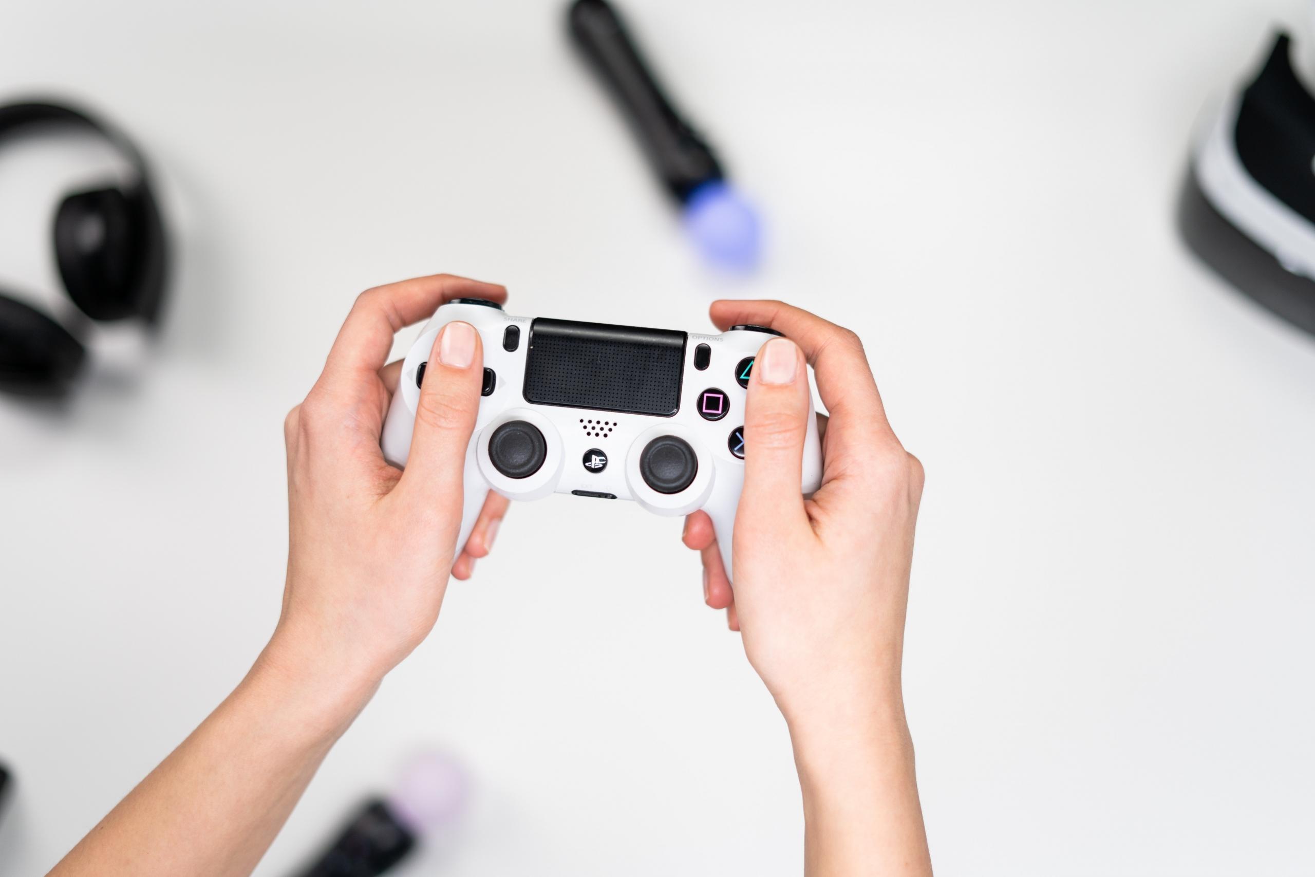 person holding white game controller