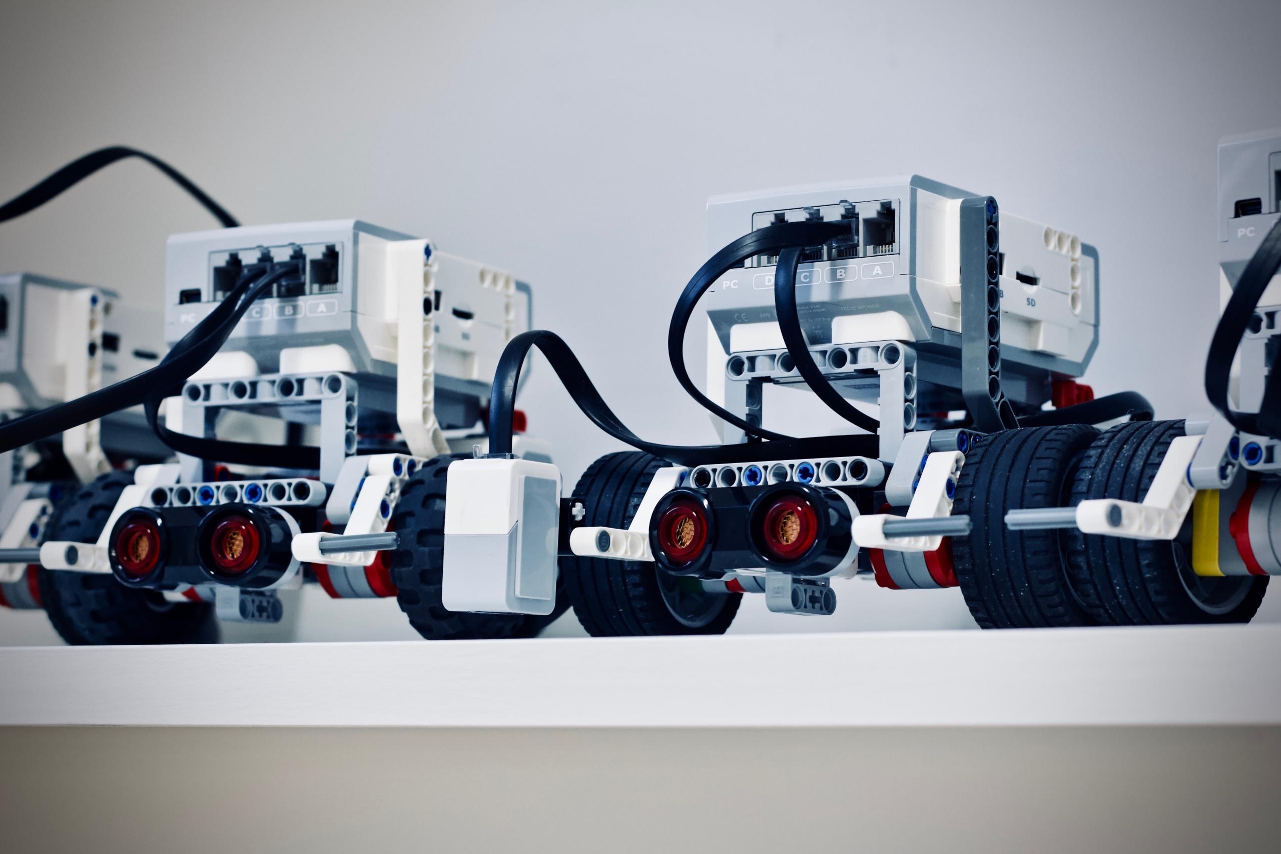 robotic vehicles lined up on a shelf