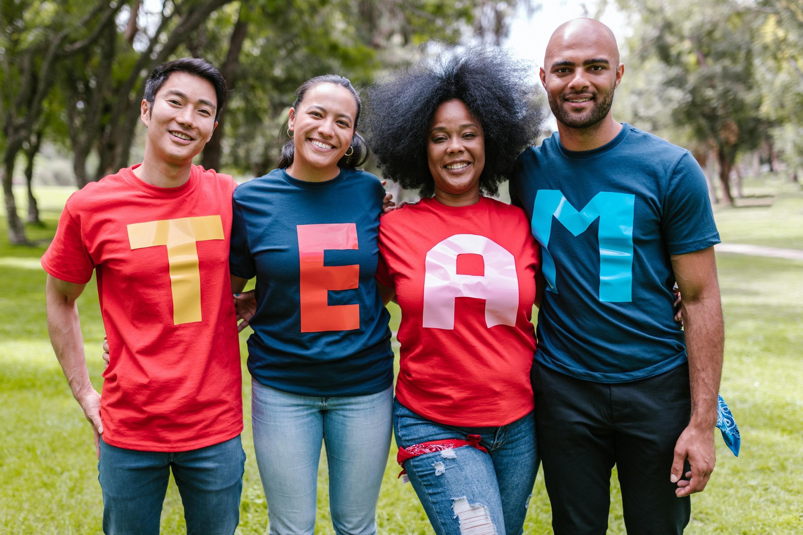 group of colleagues outdoors wearing team t-shirts