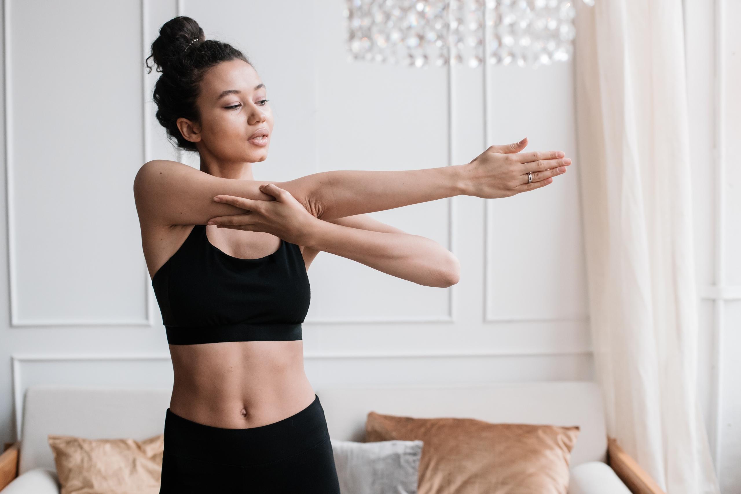 woman doing upper body stretches in living room