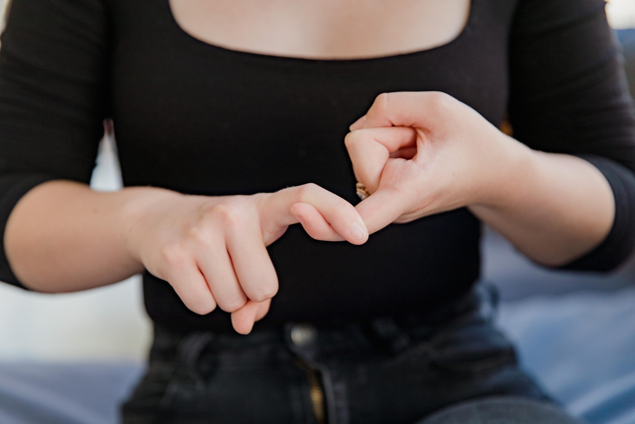 close-up of woman hands signing