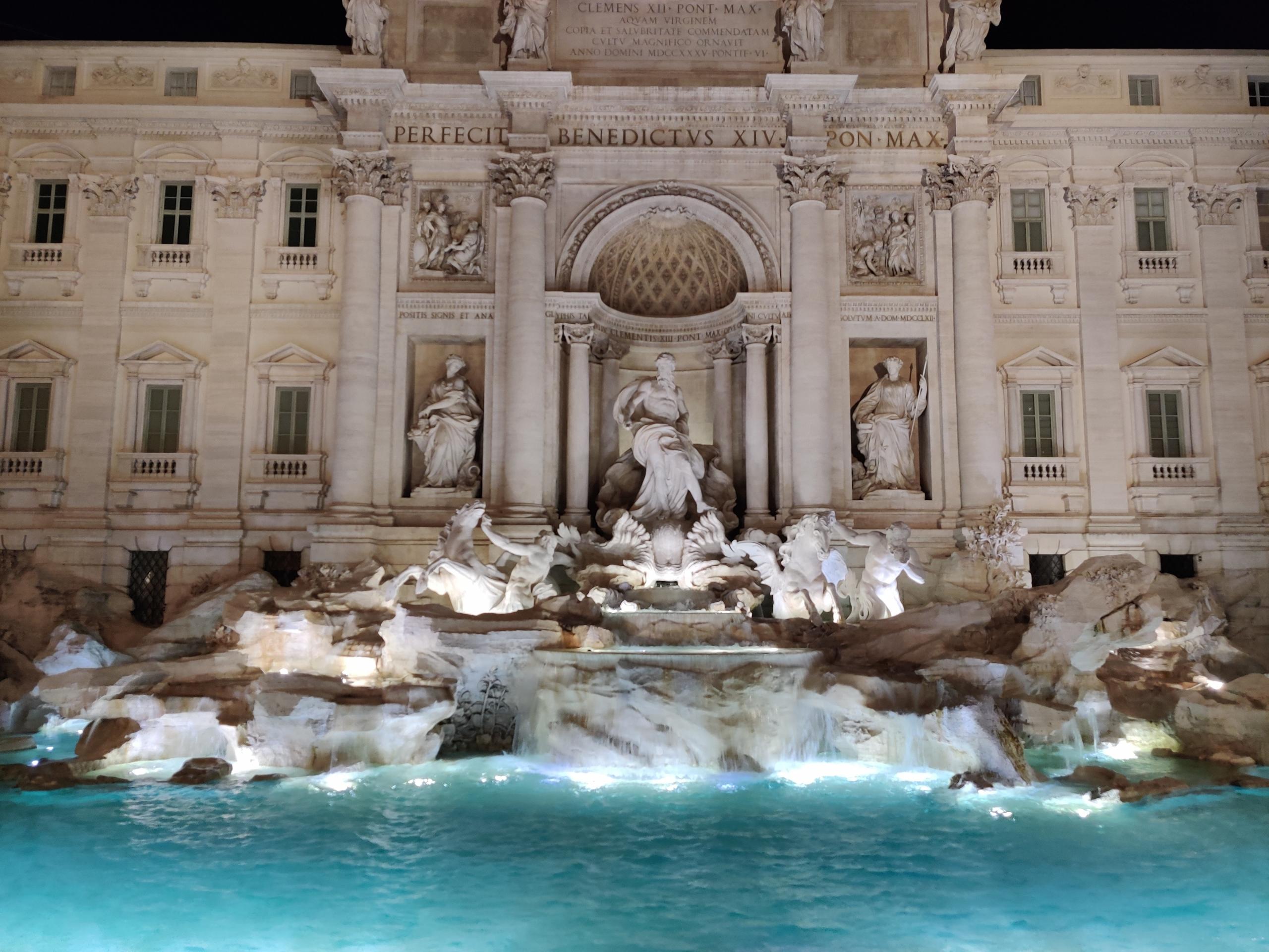 sculptures adorning Rome's Trevi Fountain seen at night