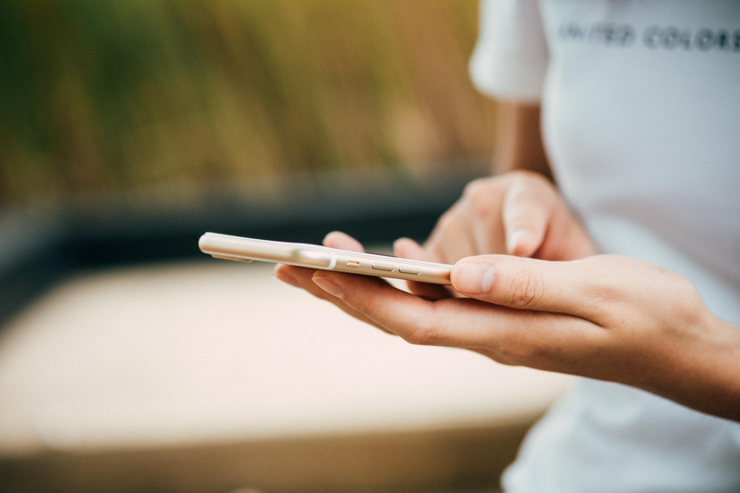 woman holding cellphone in her hands