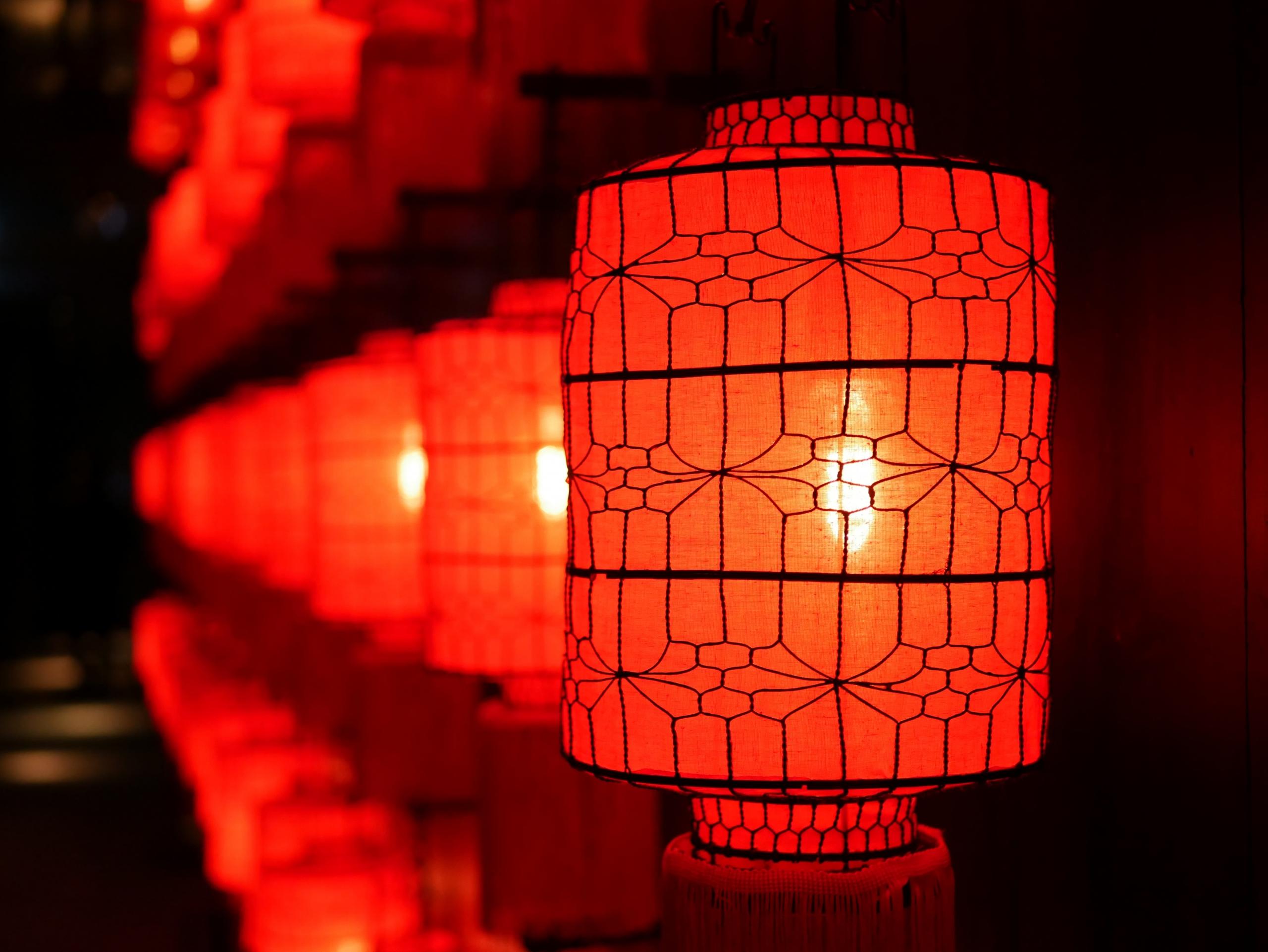 Row of red lanterns lit up at night