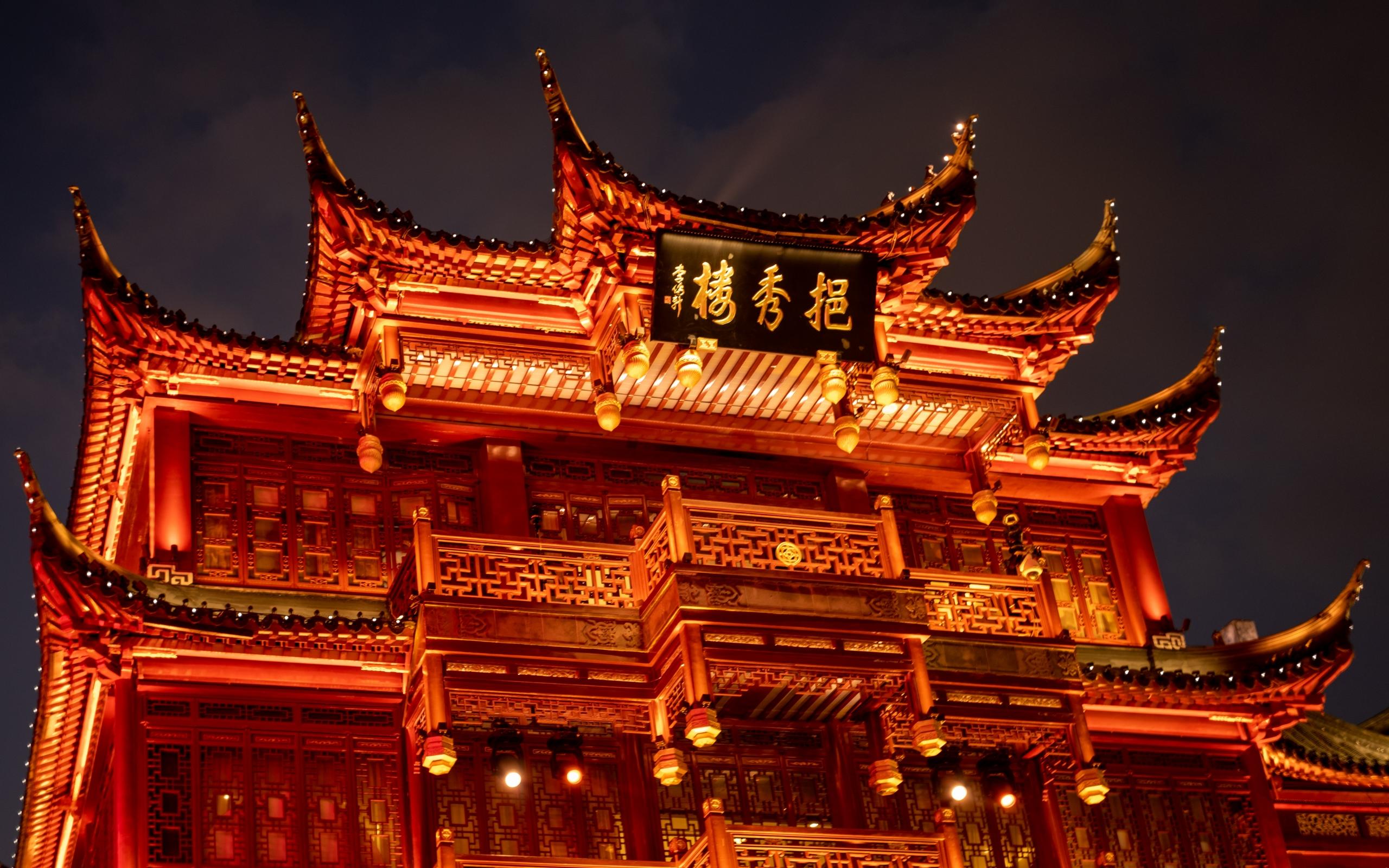 a Chinese temple at night light up in red
