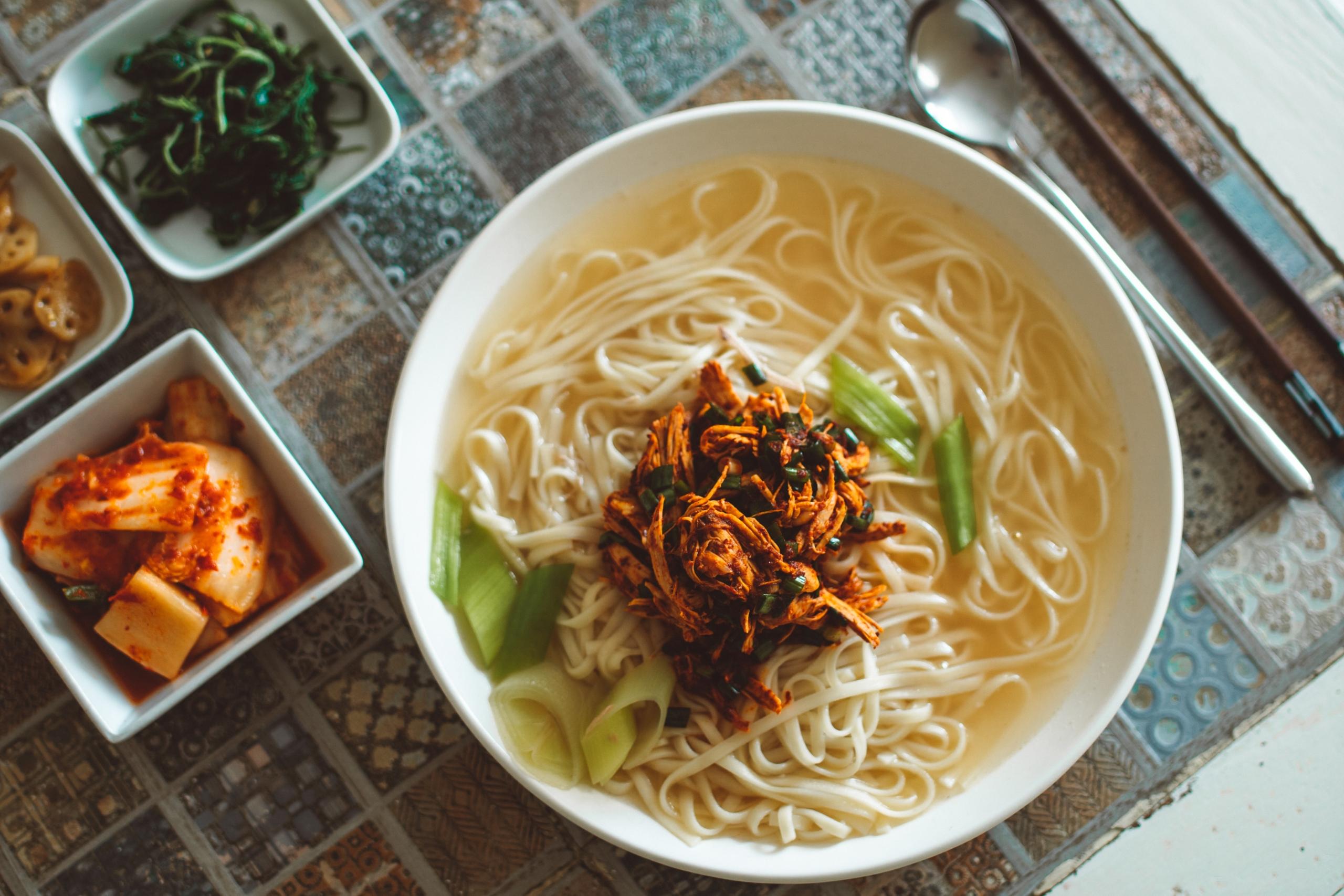 Korean Noodle Soup served with seaweed and kimchi