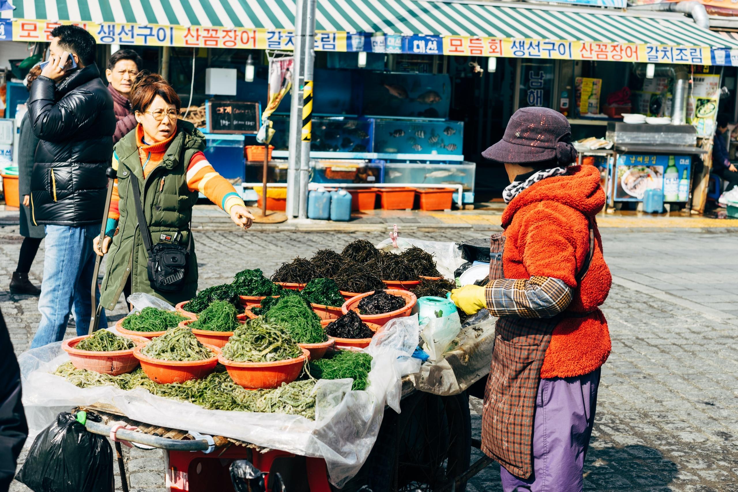 woman selling seaweed at outdoor market