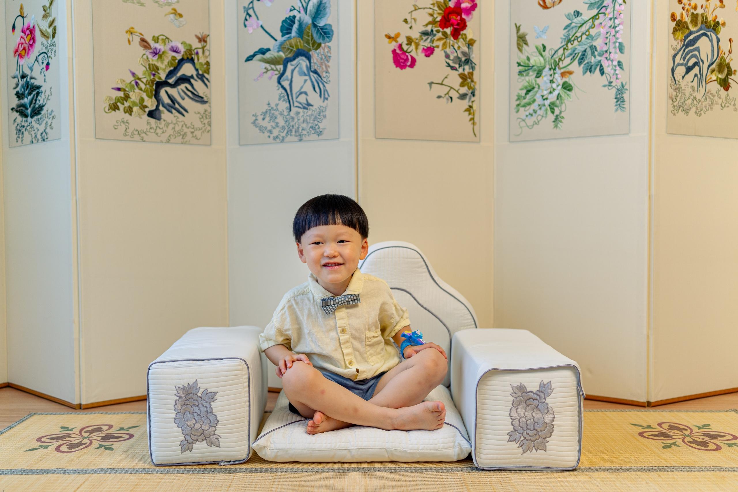 toddler boy sitting cross legged
