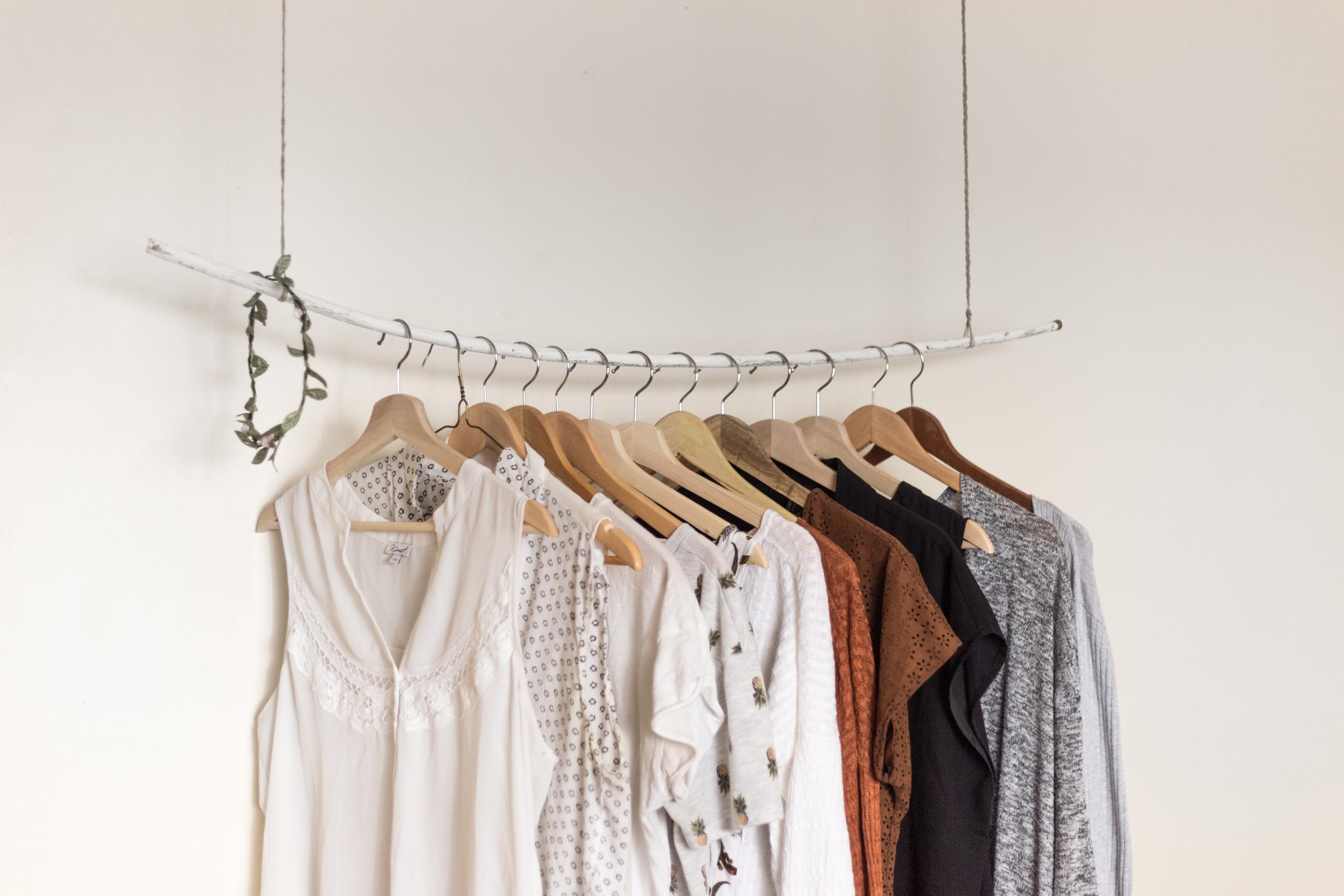 minimalist shop showcasing clothes on hangers