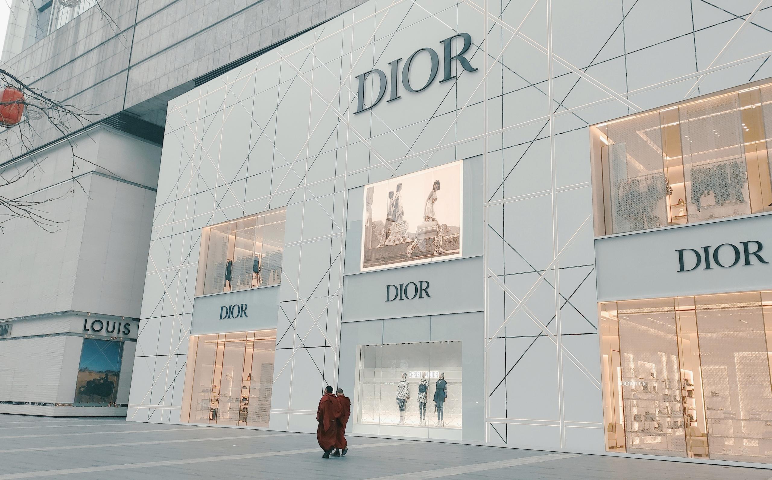 People walking past a flagship Dior store