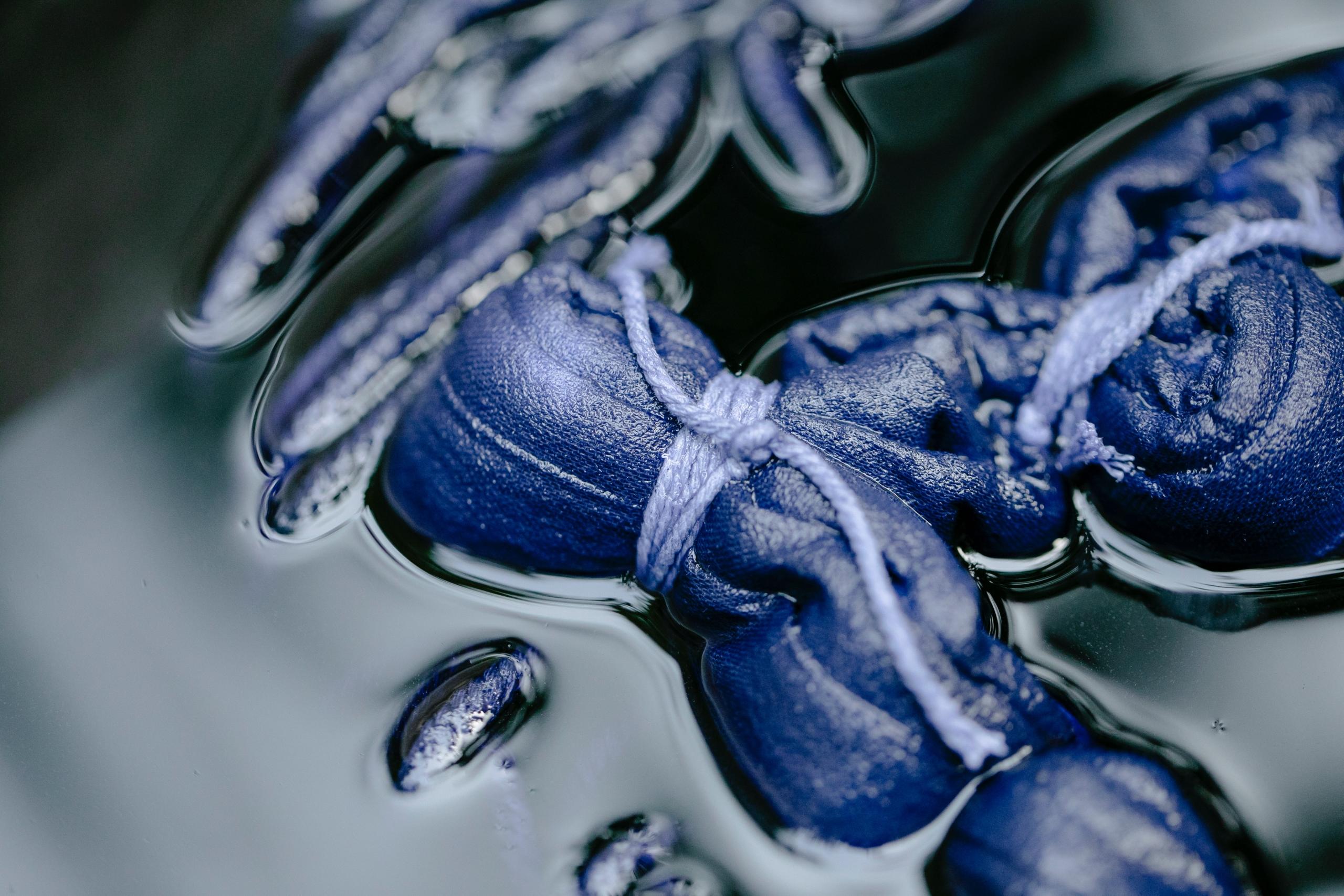 indigo denim in a tub of fabric dye