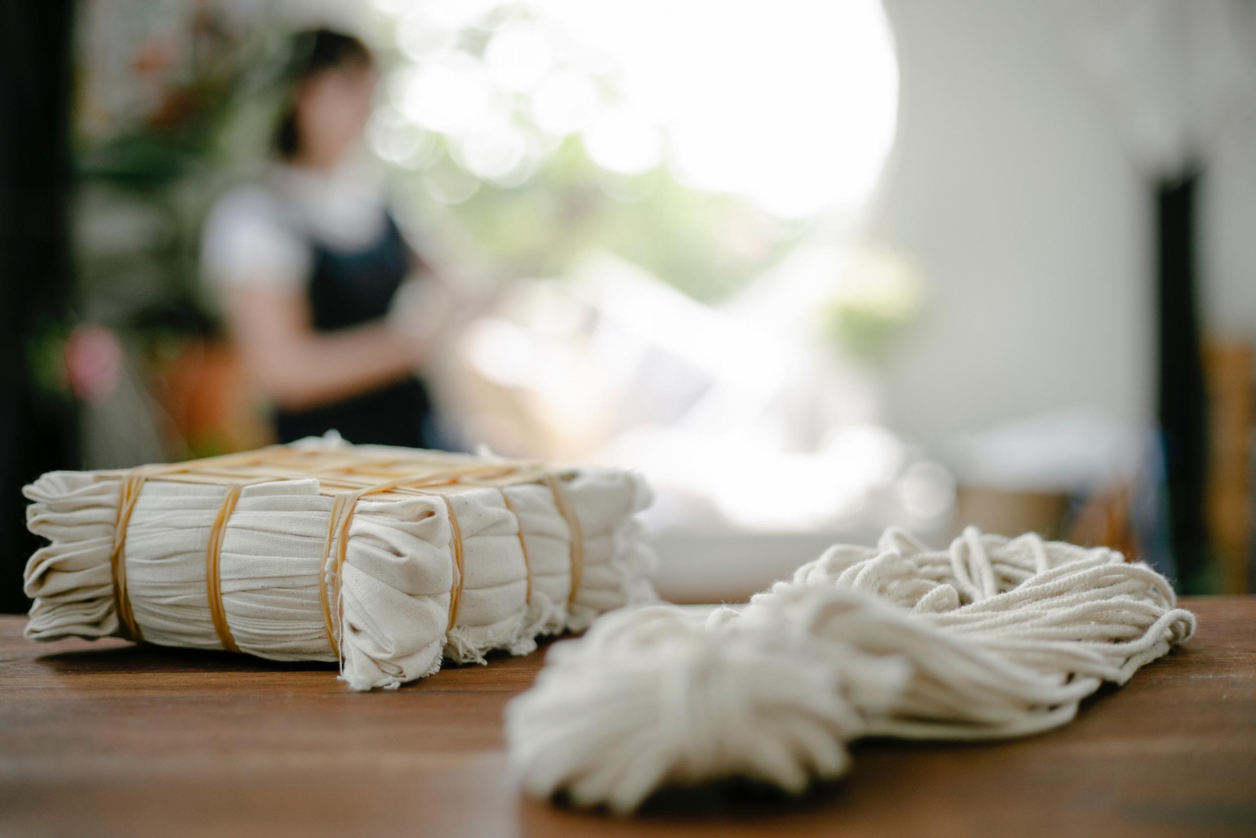 strips of undyed cotton fabric placed on wooden table