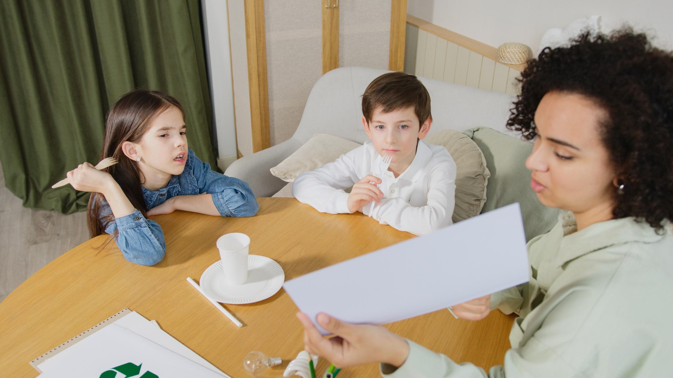 private tutor teaching two siblings in their living room