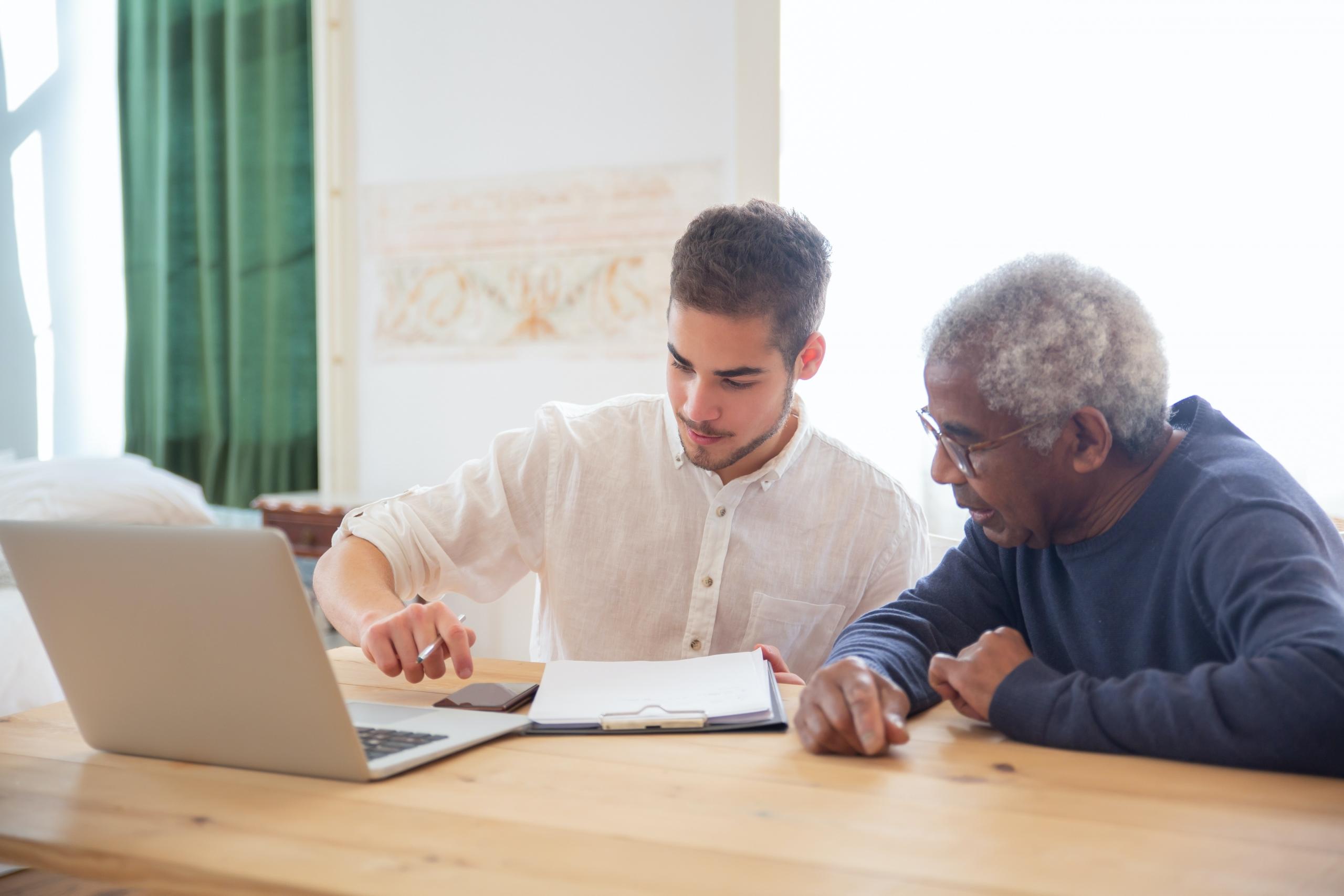 elderly tutor helping teen do Maths