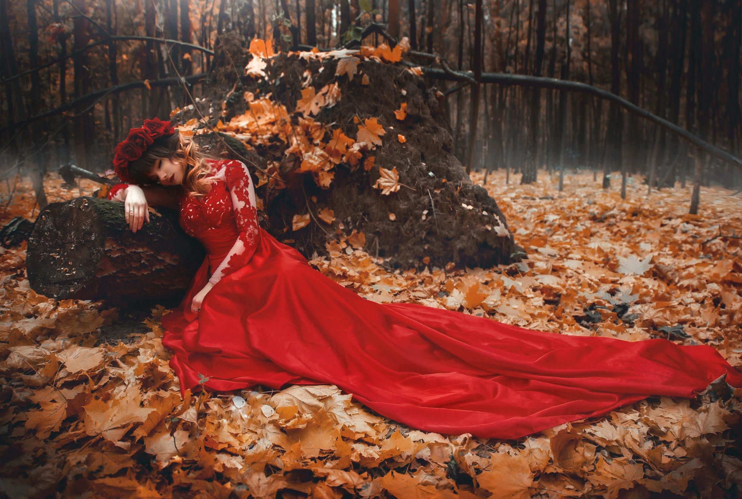 haute couture photoshoot in forest strewn with autumn leaves