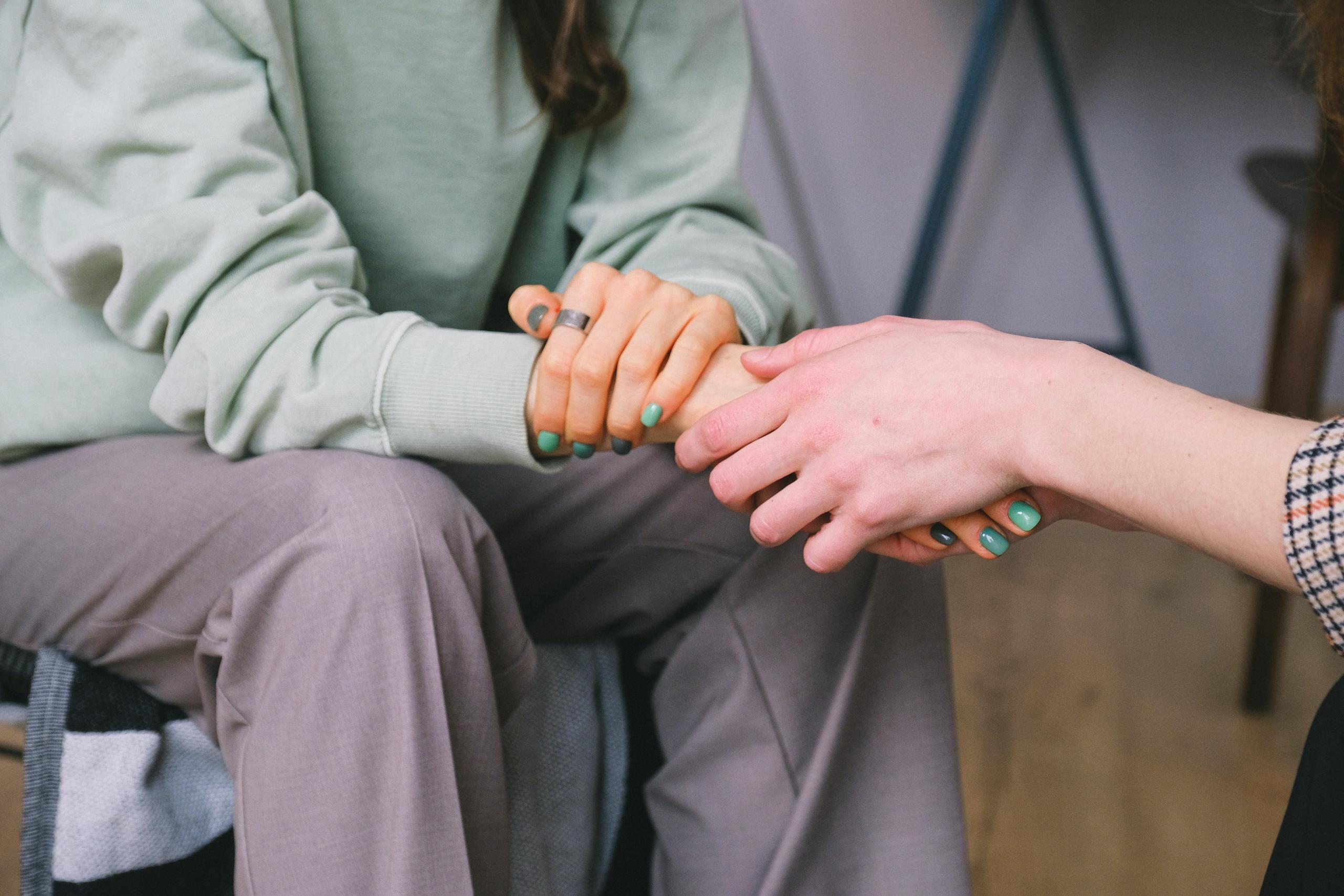 two people having deep discussion and holding hands