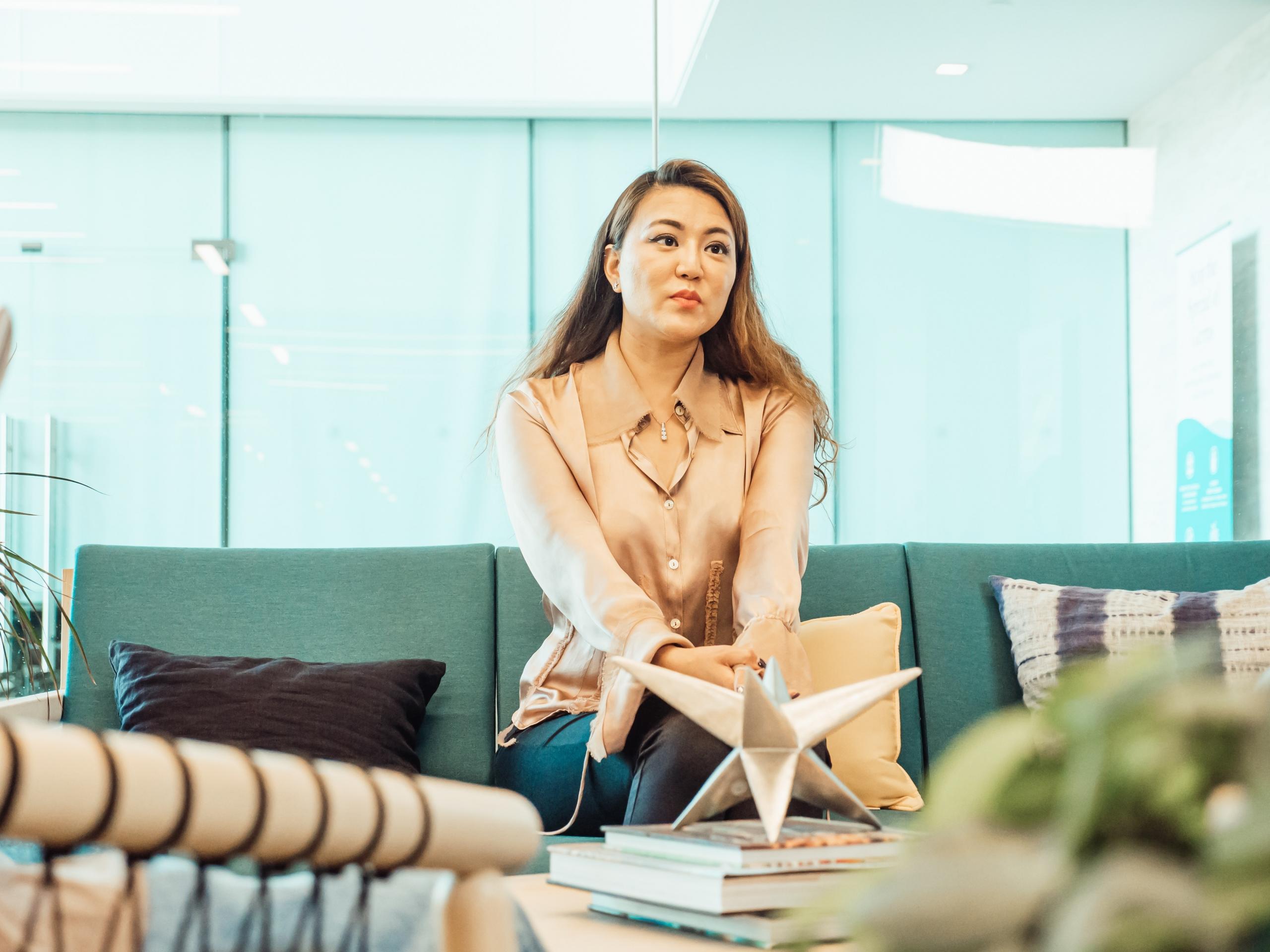 person sitting on sofa in waiting area in office building