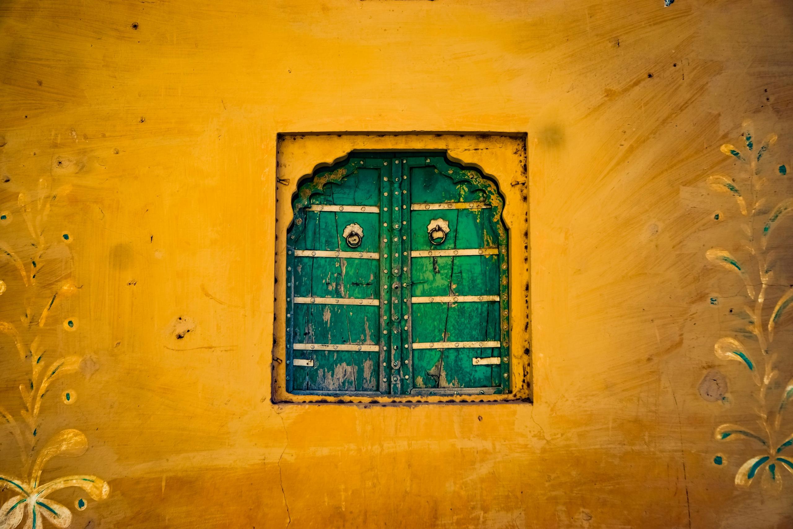 emerald green shutters and ochre wall in India