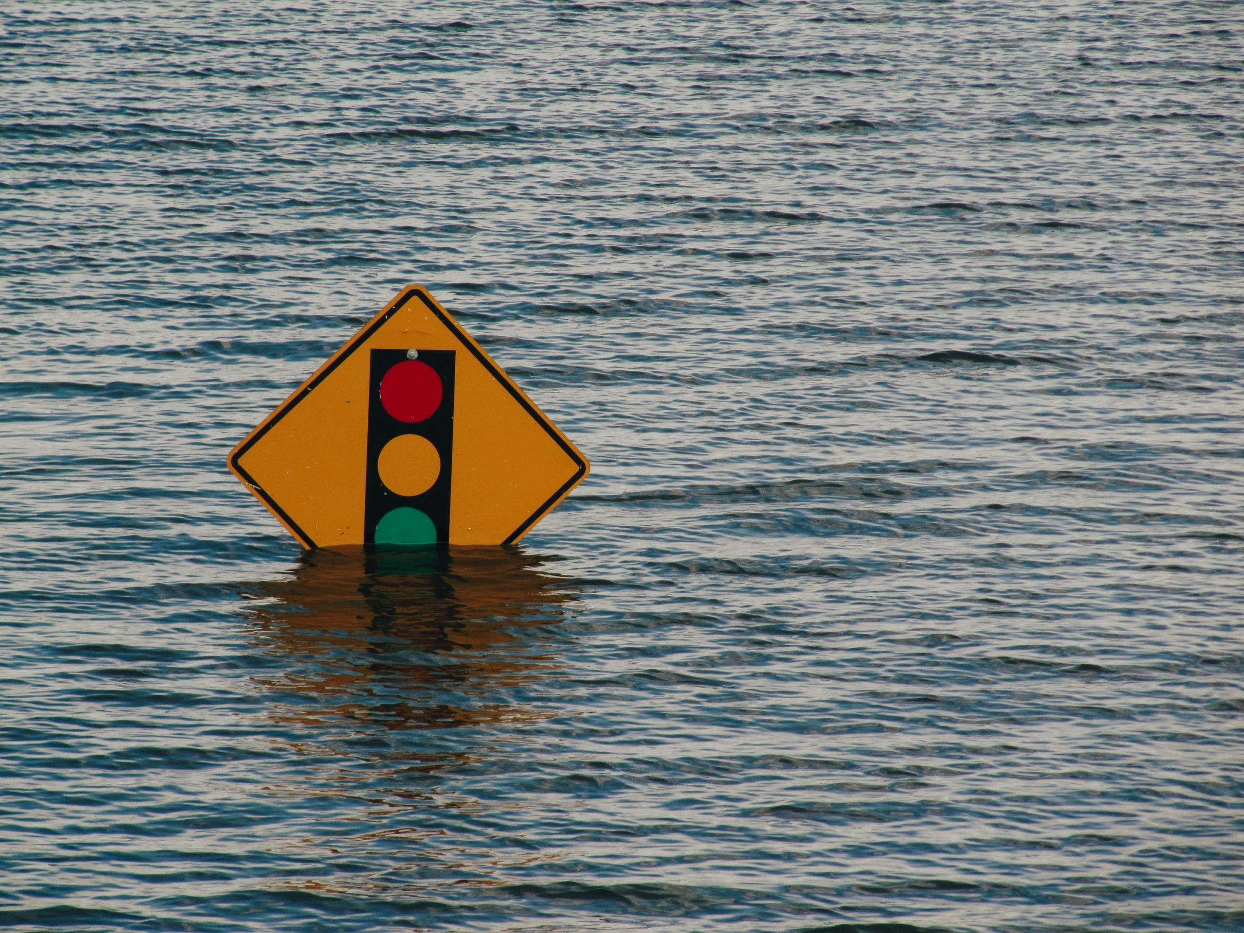street sign submerged in flood waters