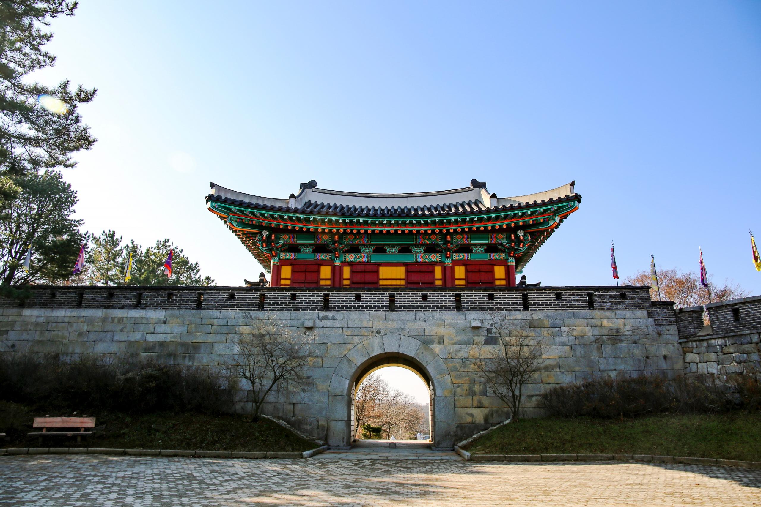 traditional temple in Korea build on top of stone wall with arched walkway