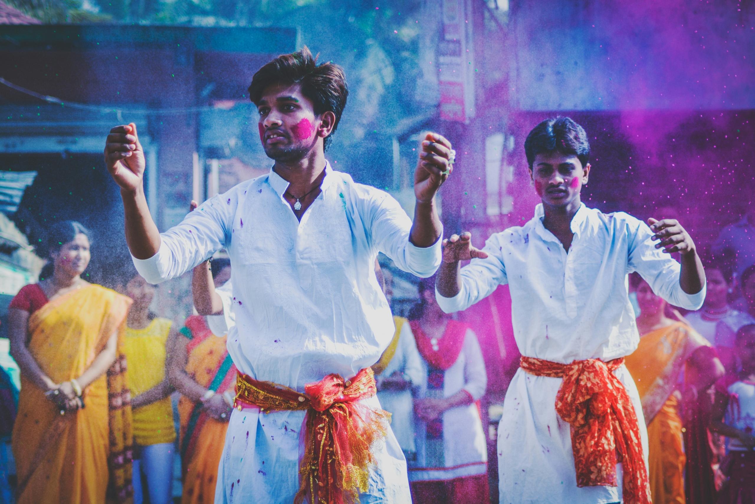 coloured powder being thrown in the air during festival on the streets of India