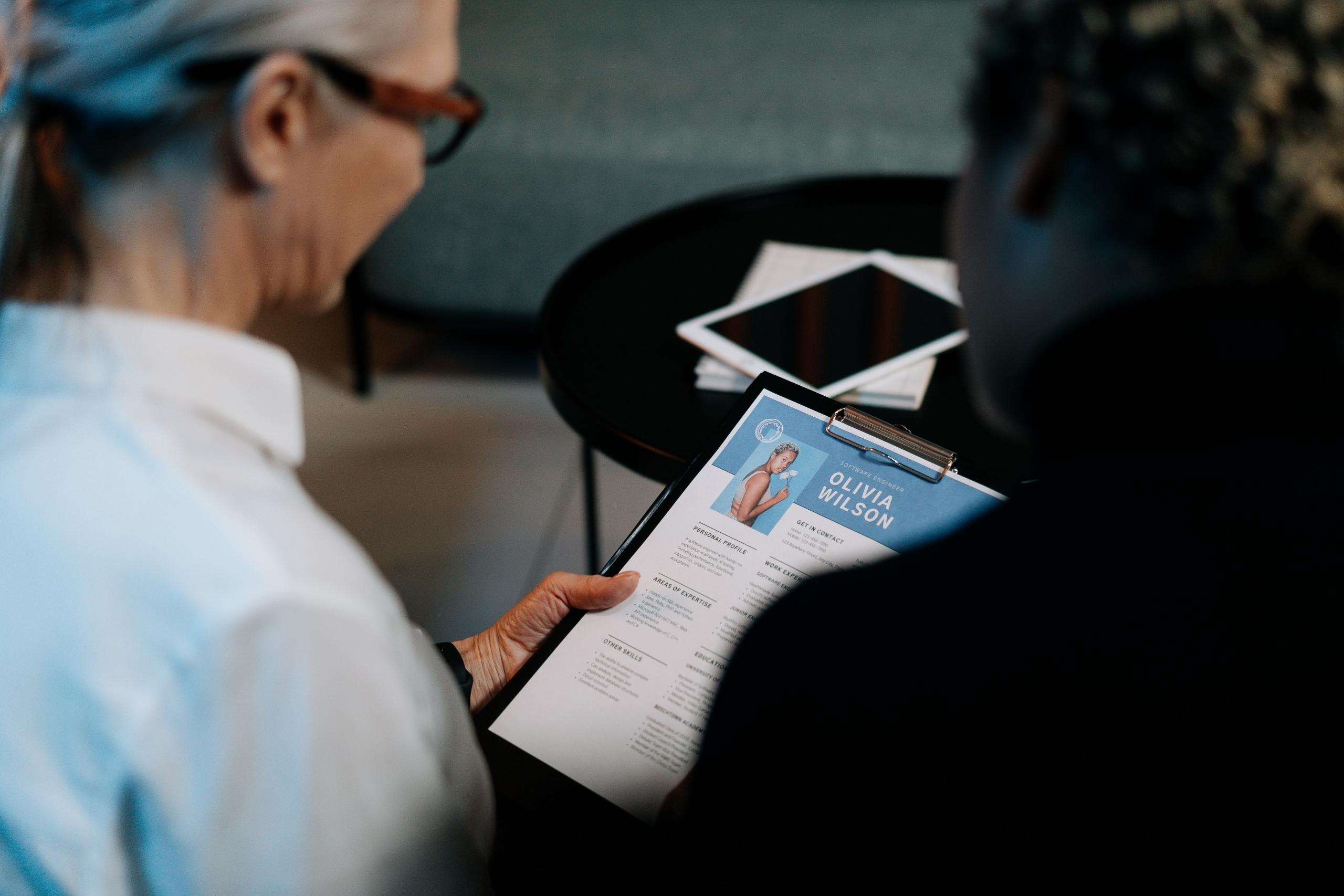 two women reviewing the CV of female job applicant