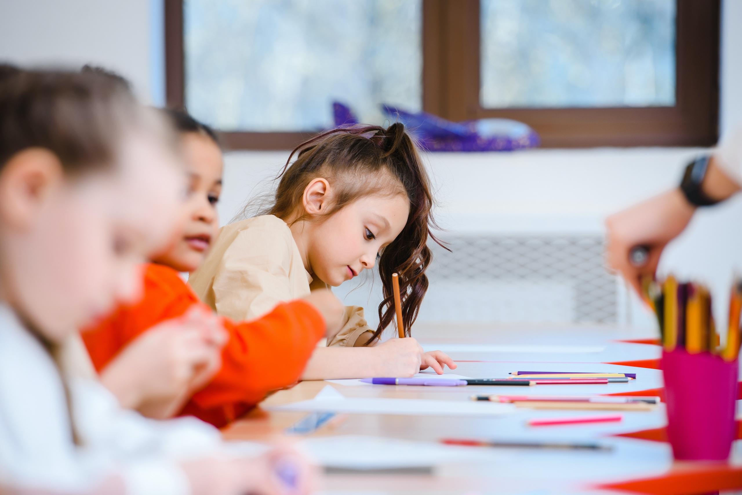 group of small children drawing in preschool