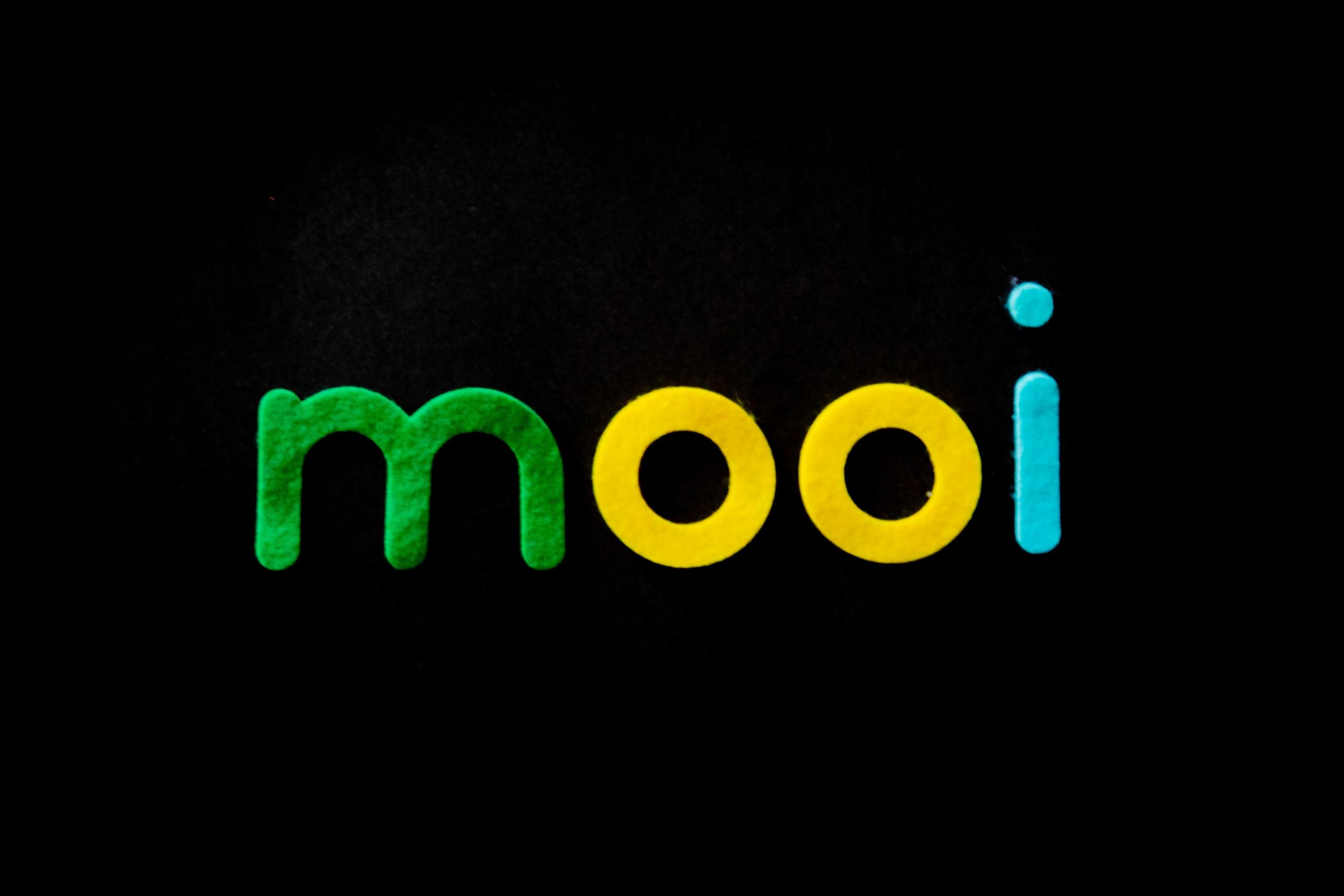 afrikaans word written in multicoloured felt on black background