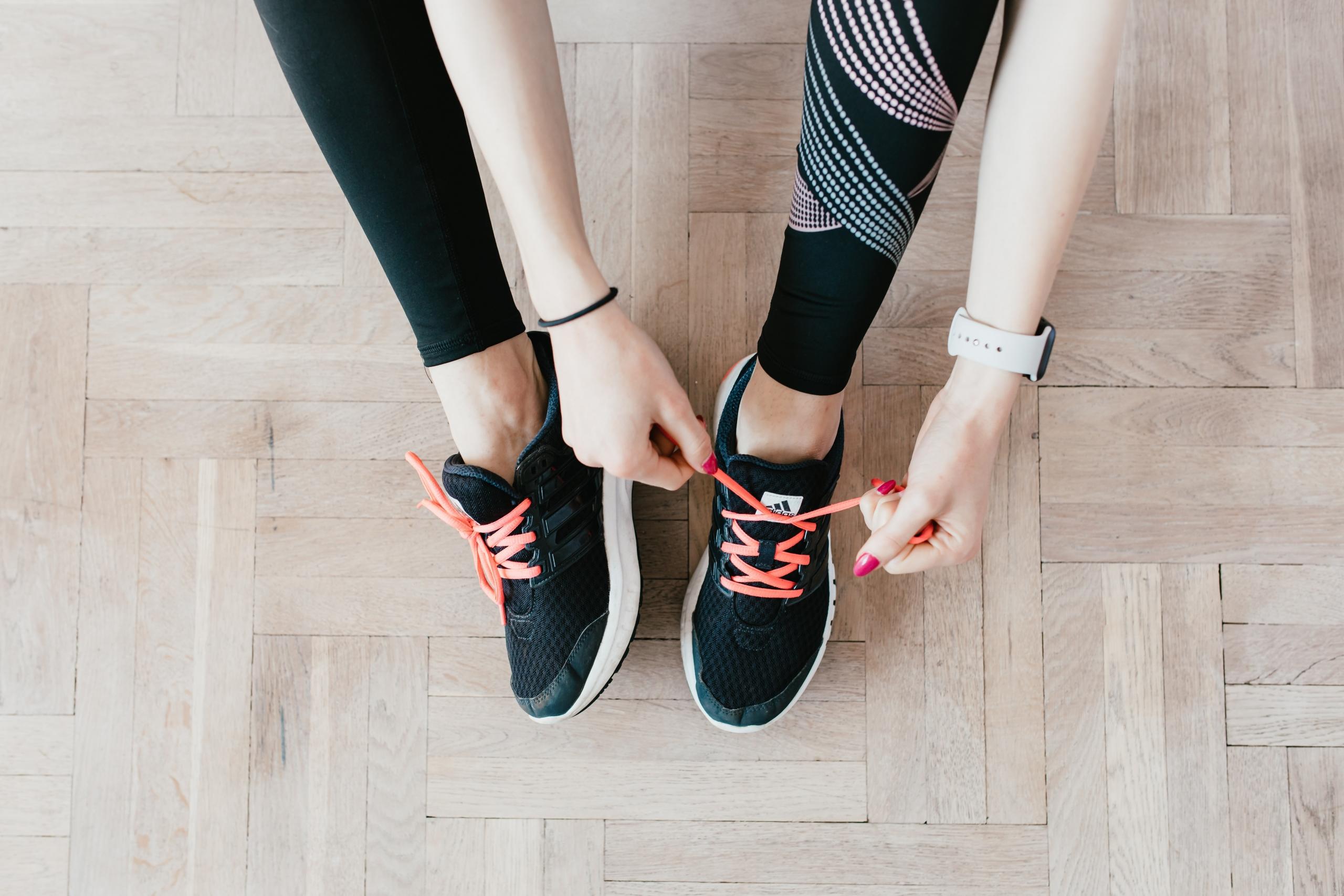 sportswoman in leggings and sports shoes getting ready to workout