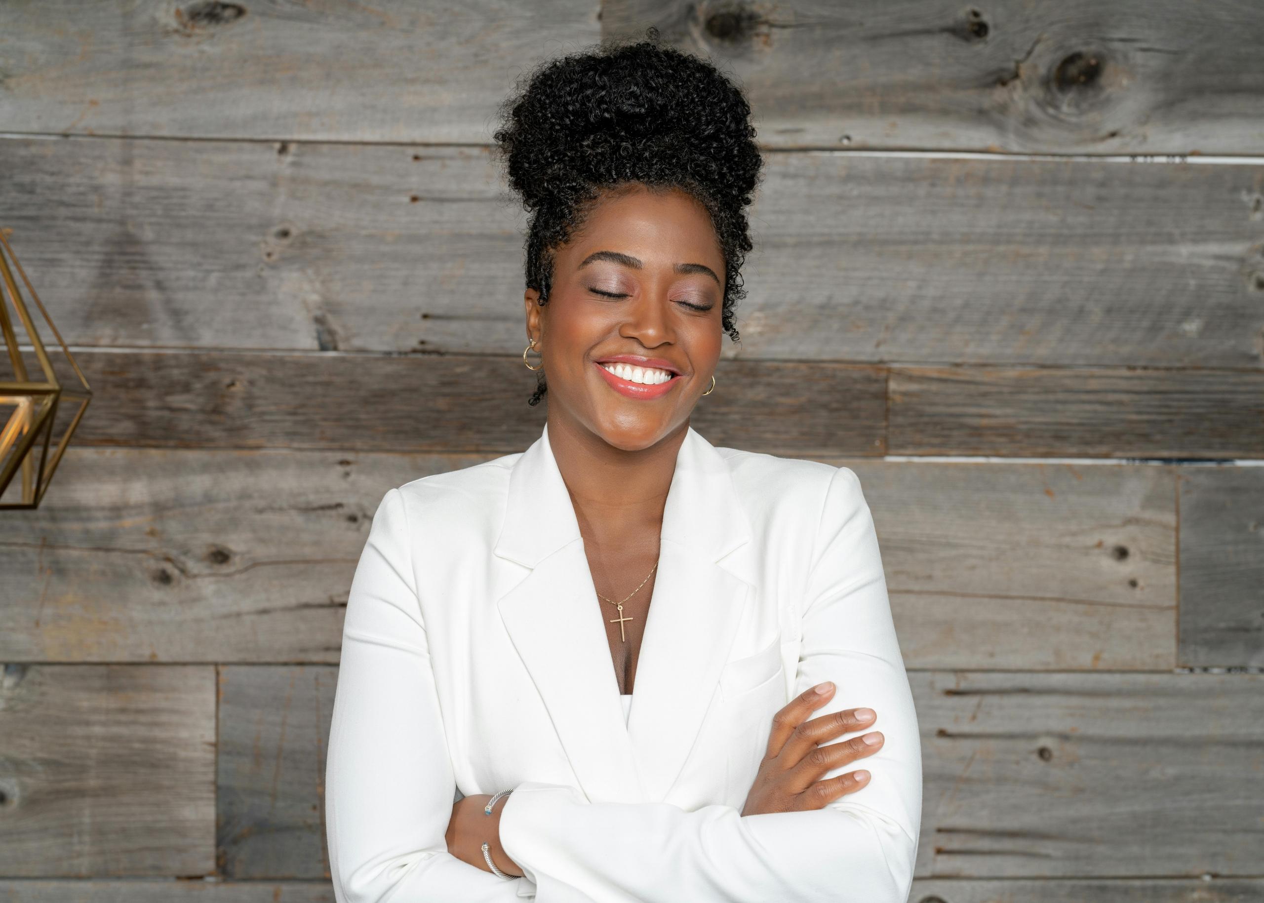 successful woman wearing tailored business suit and smiling with her eyes closed