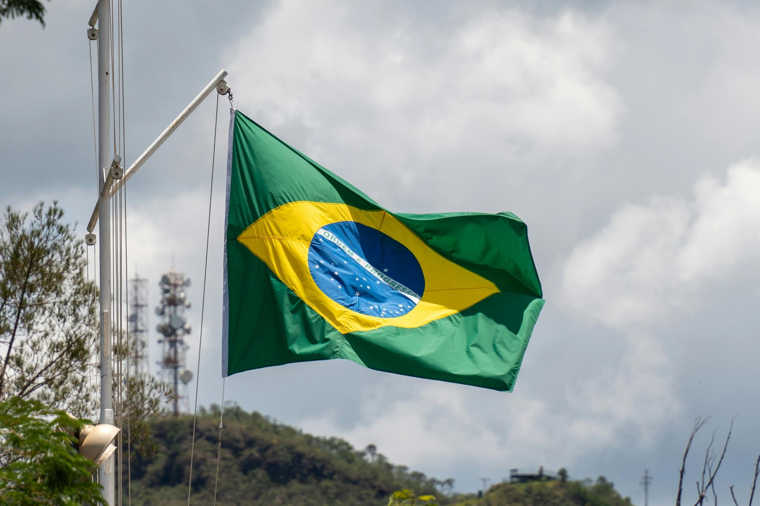 Brazilian flag on flagpole blowing in the wind