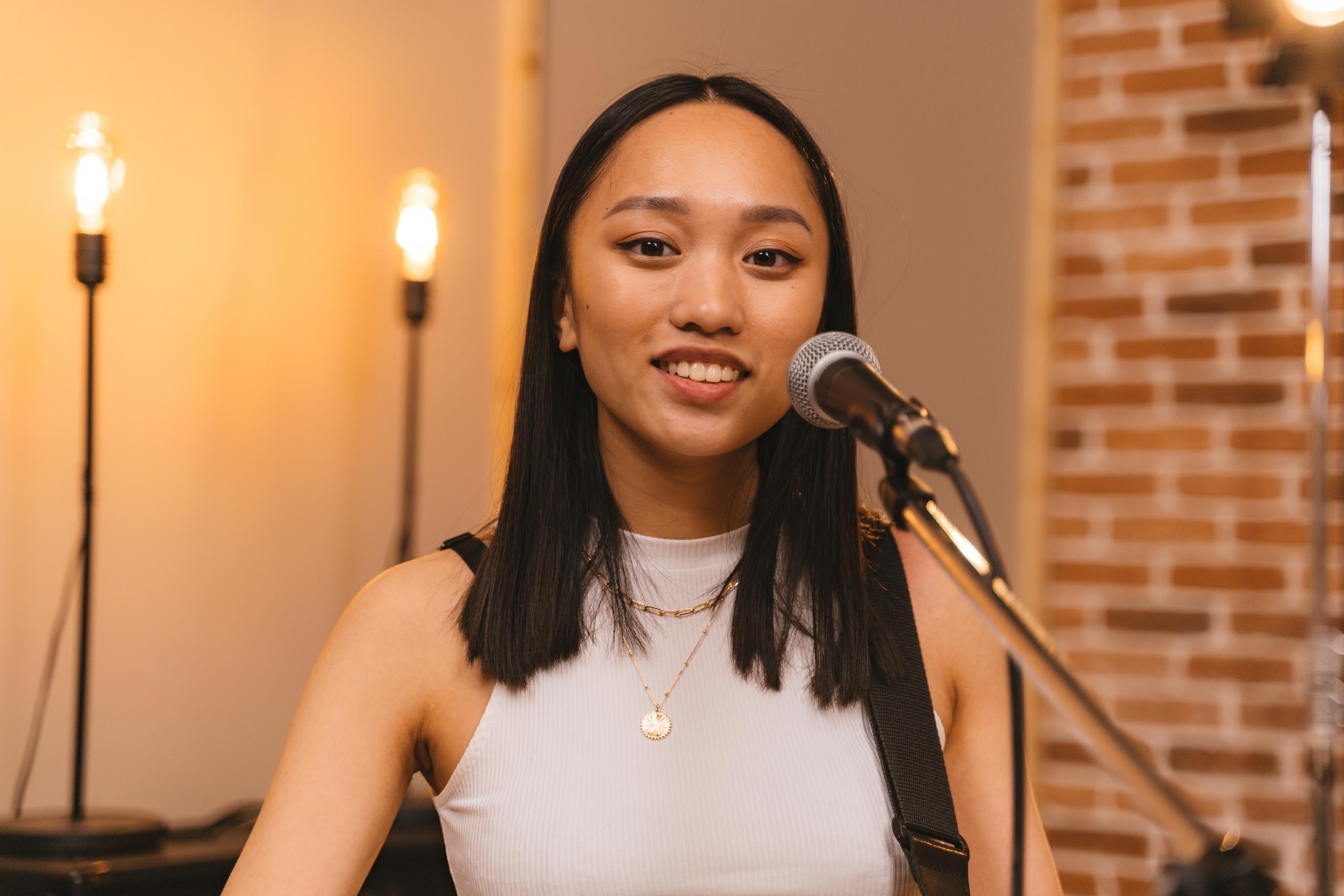 person singing into mic in studio