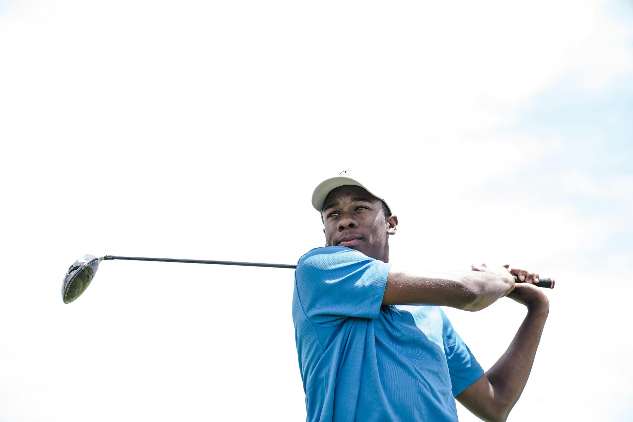 golfer swinging golf club over his shoulder