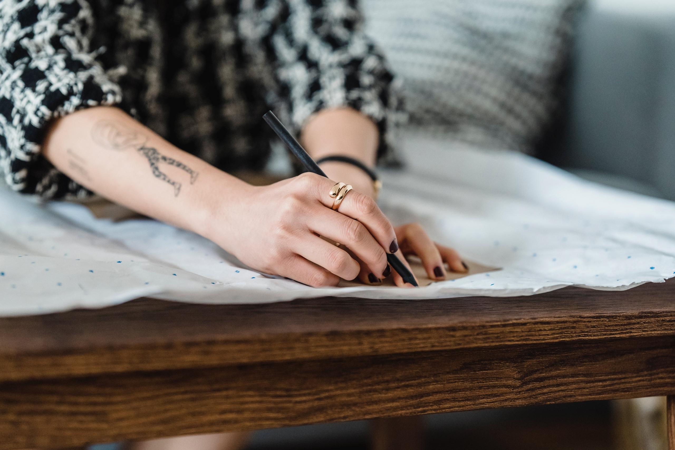 designer tracing pattern onto material