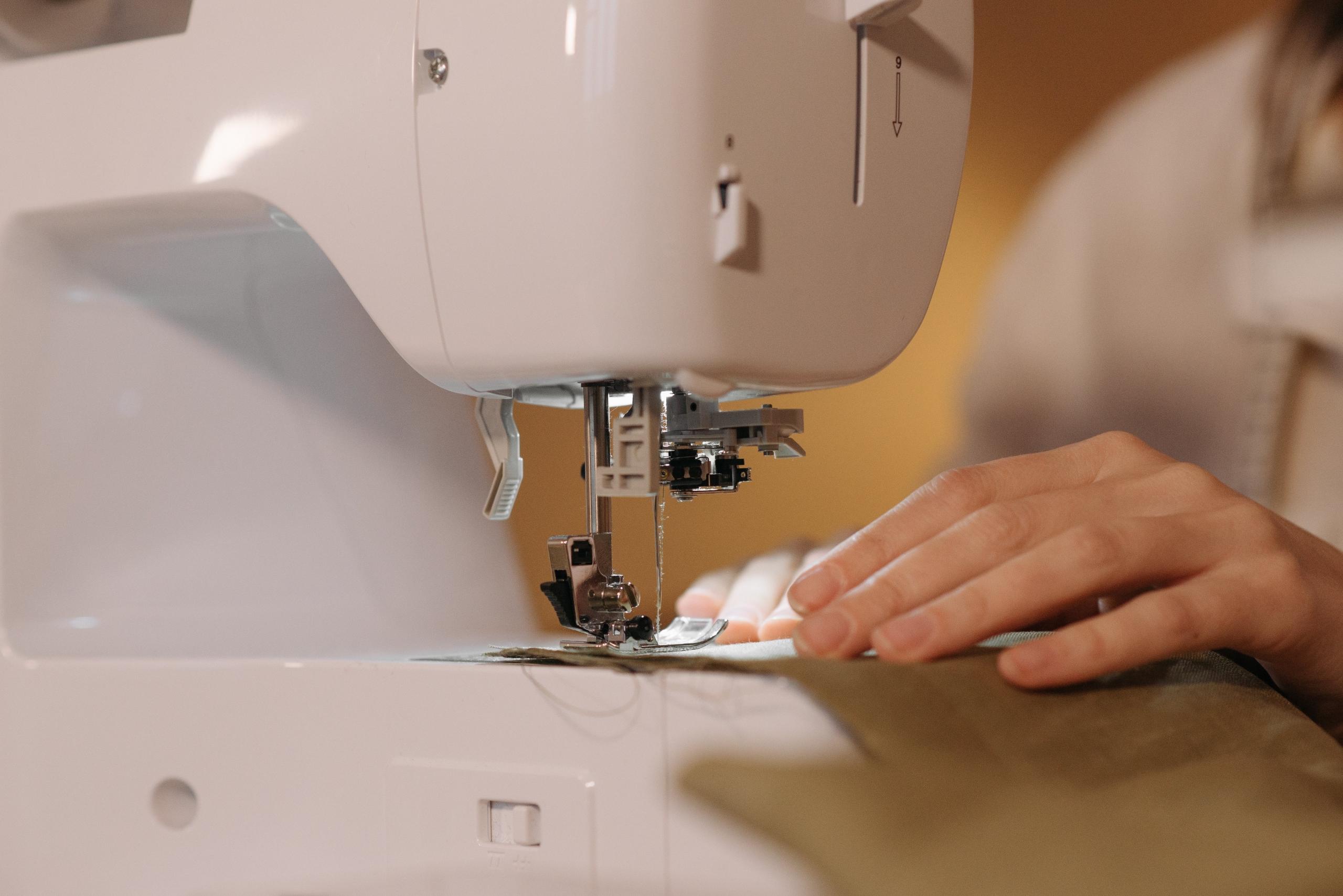 person using electric sewing machine