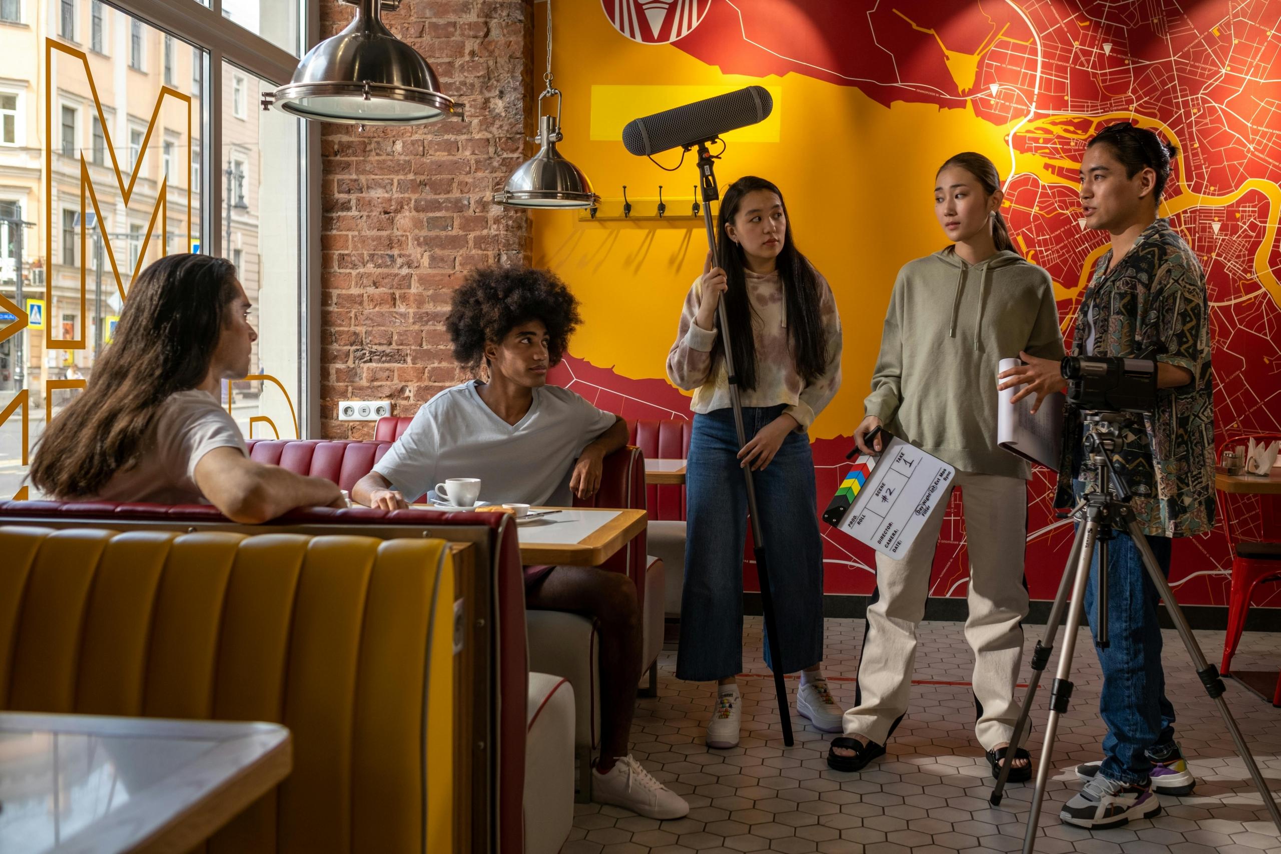 actors and crew on movie set inside a café