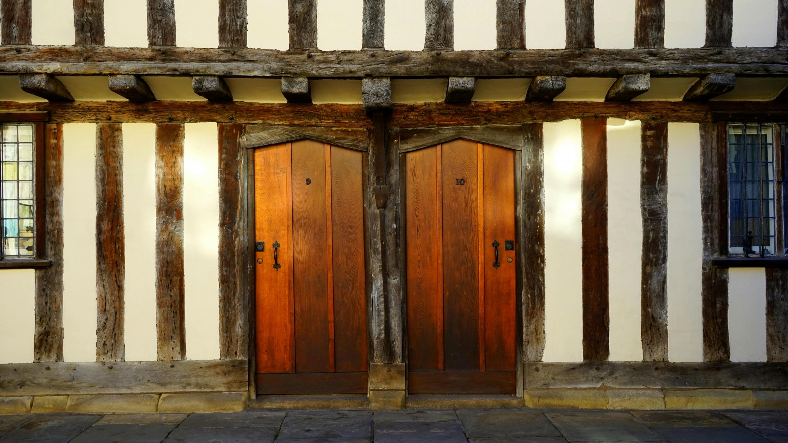 two terraced tudor houses with wooden front doors