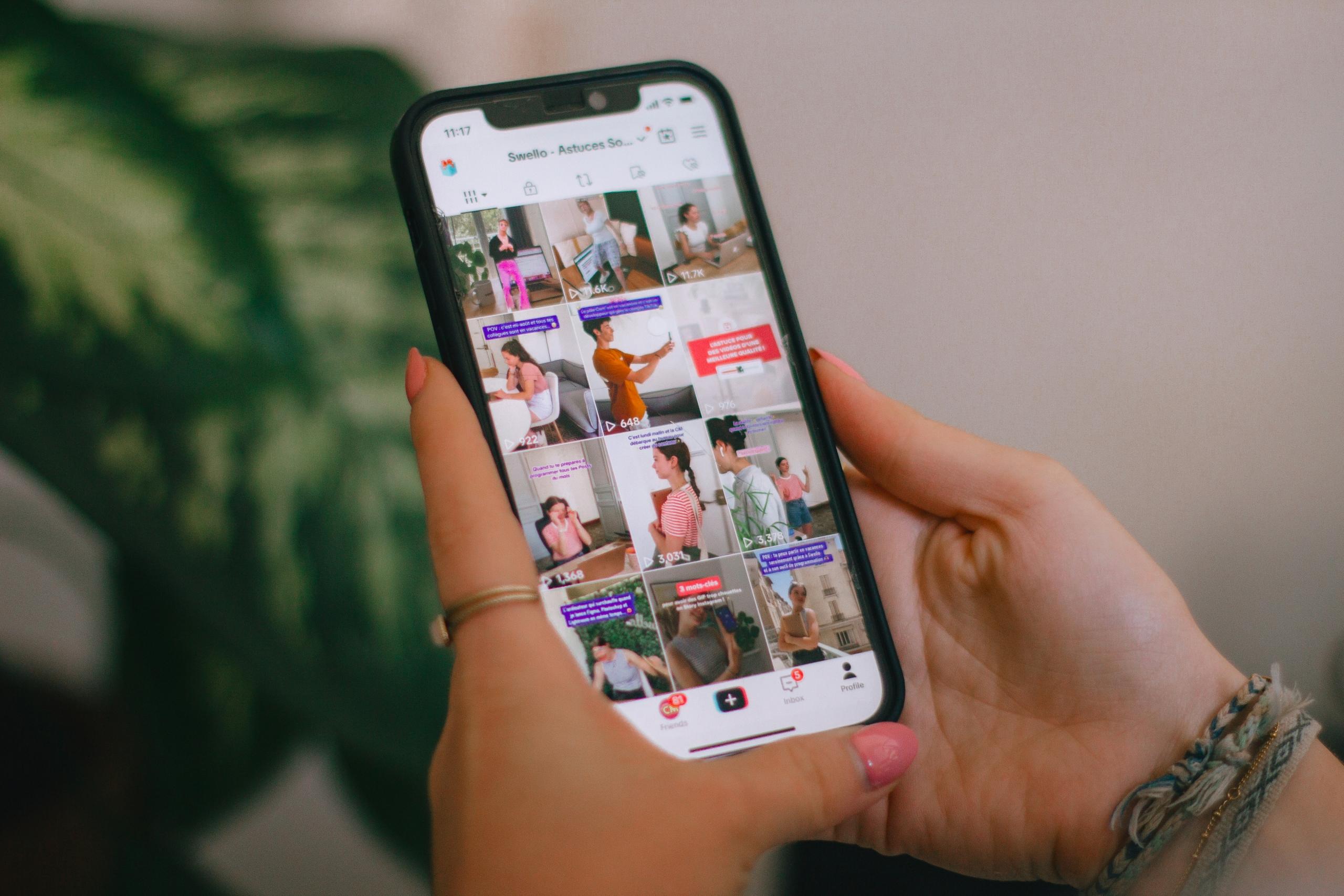 a person holding a cell phone in their hand